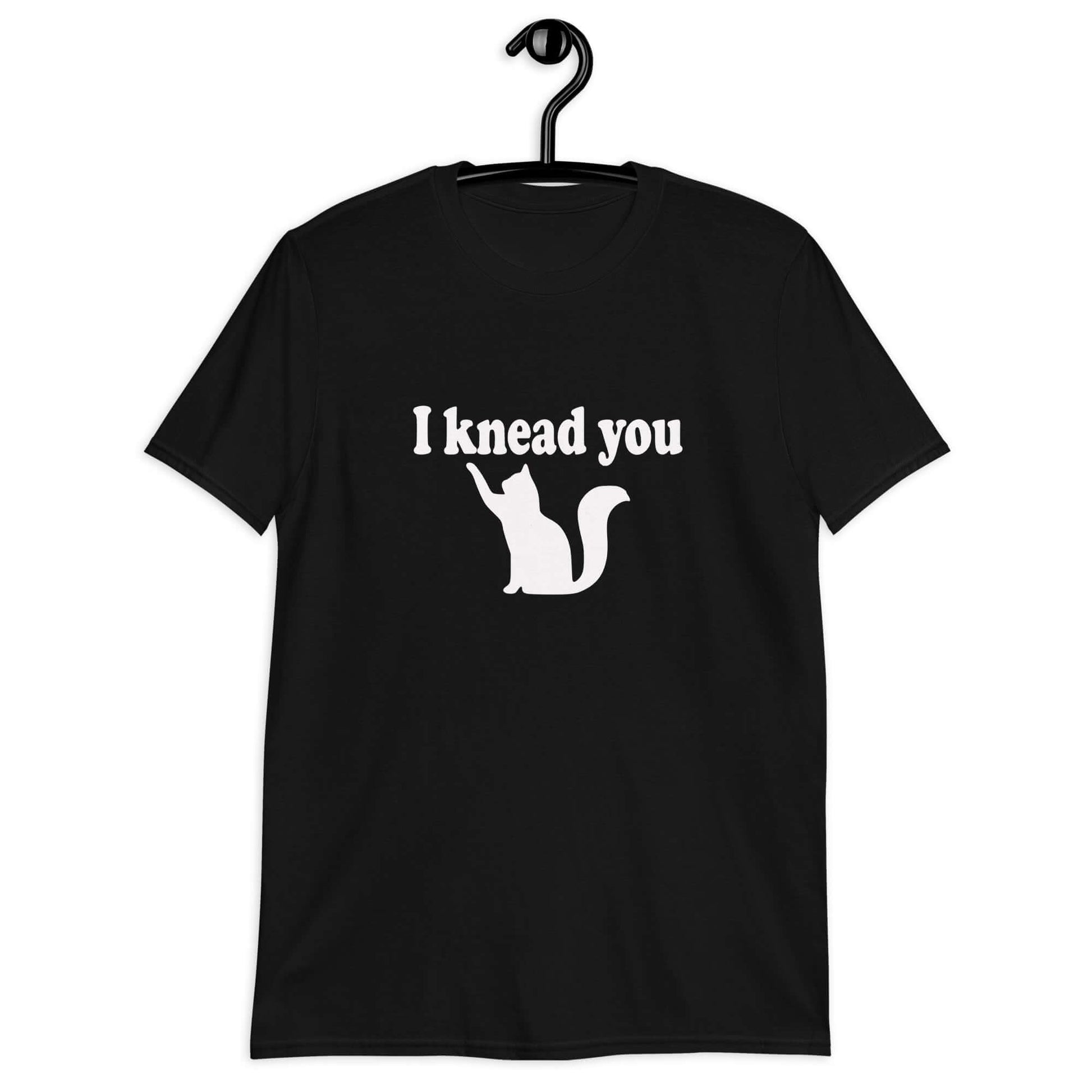 Black t-shirt that has an image of a silhouette of a cat and the words I knead you printed on the front.