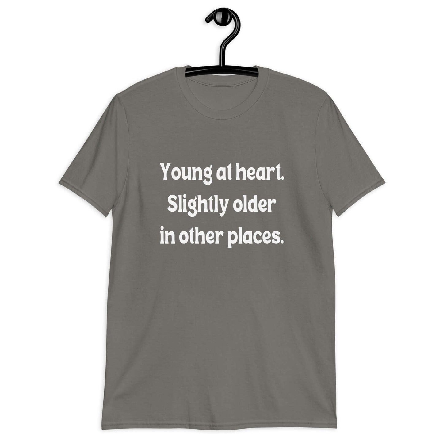 Charcoal grey t-shirt with the words Young at heart, slightly older in other places printed on the front.