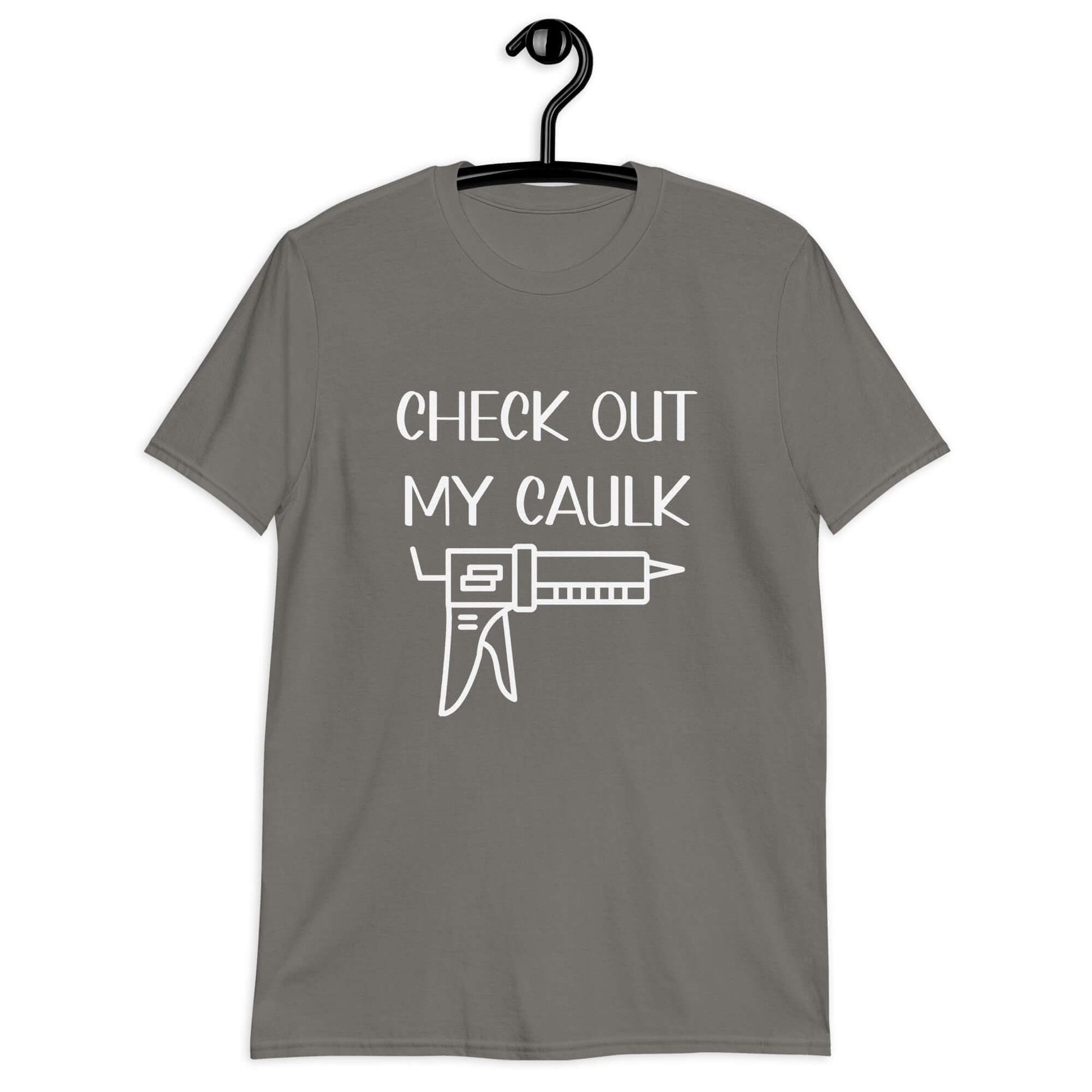 Charcoal t-shirt with the pun phrase Check out my caulk with a line drawing image of a caulking gun printed on the front.