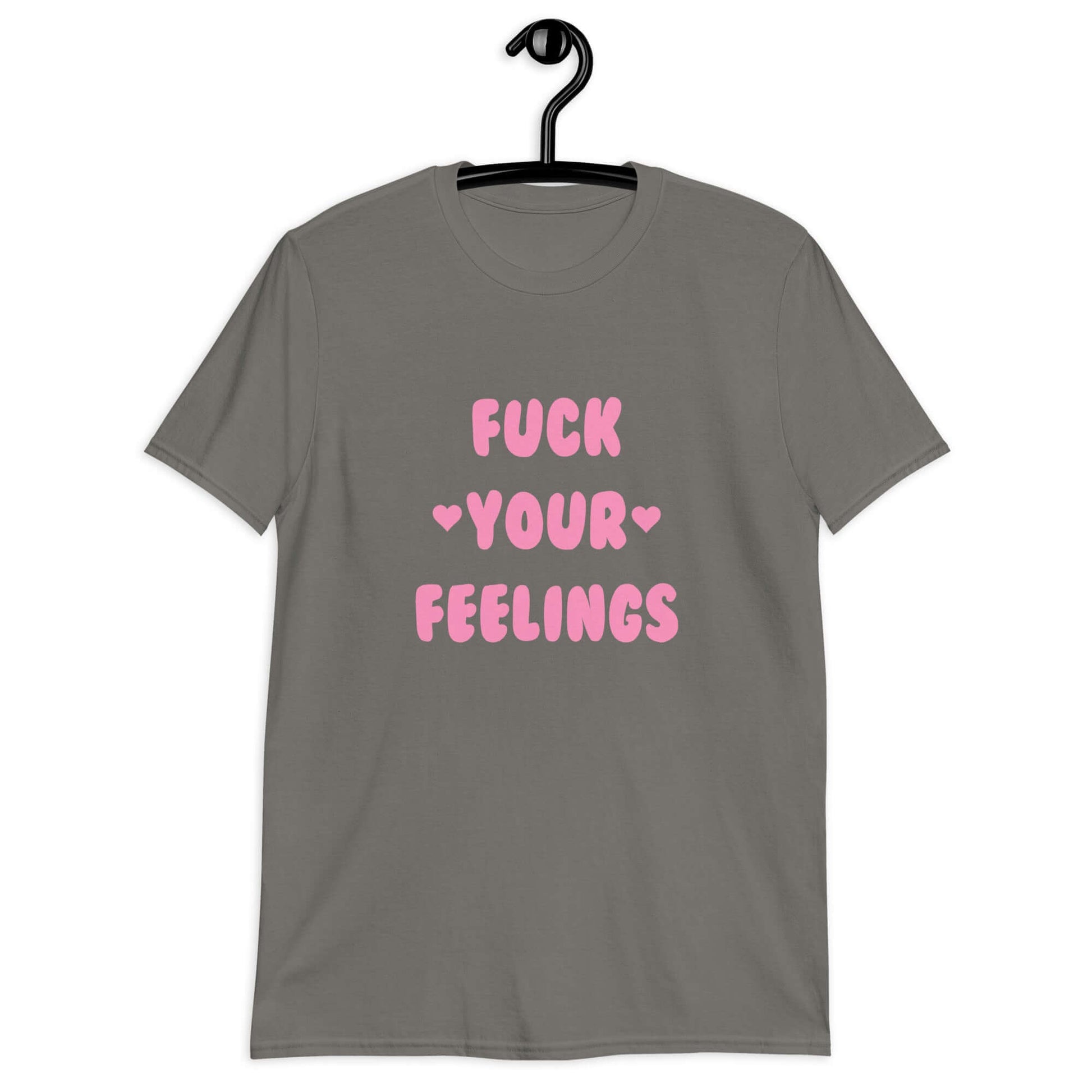 Charcoal t-shirt with the words Fuck your feelings printed on the front in pink. There are cute pink hearts next to the words.