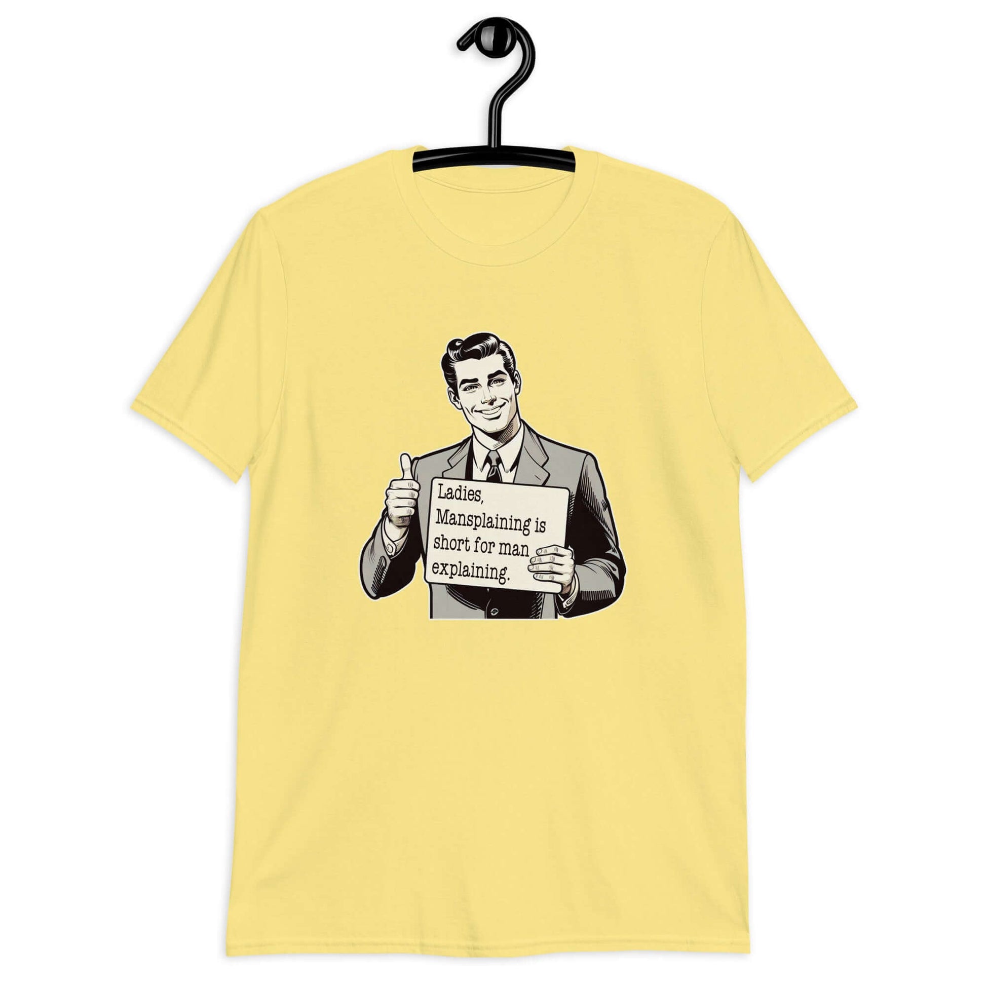 Cornsilk yellow t-shirt with a graphic of a retro man holding a sign. The sign says Ladies, mansplaining is short for man explaining. The graphics are printed on the front of the shirt.