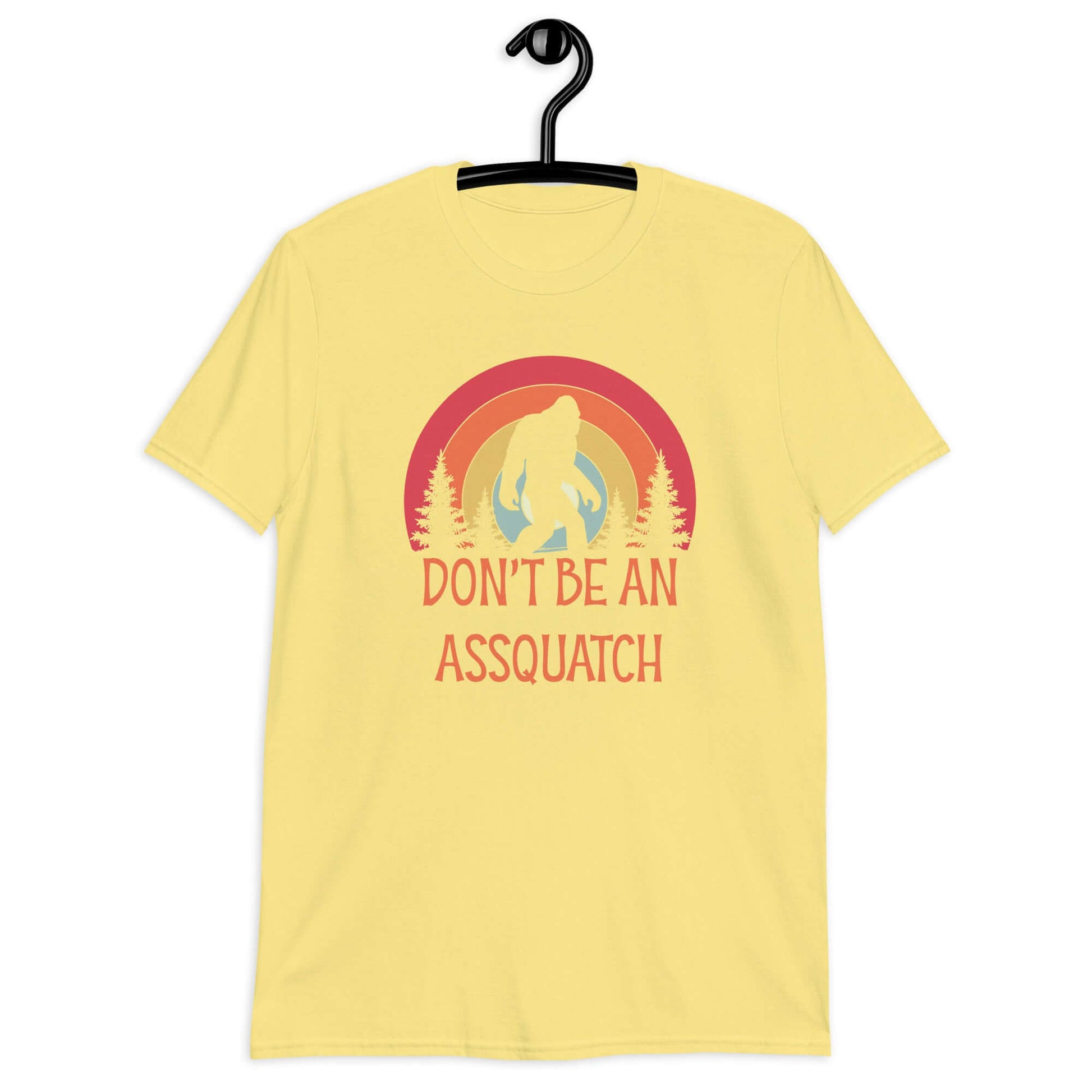 Cornsilk yellow t-shirt with sasquatch graphic and the words don't be an assquatch printed on the front.