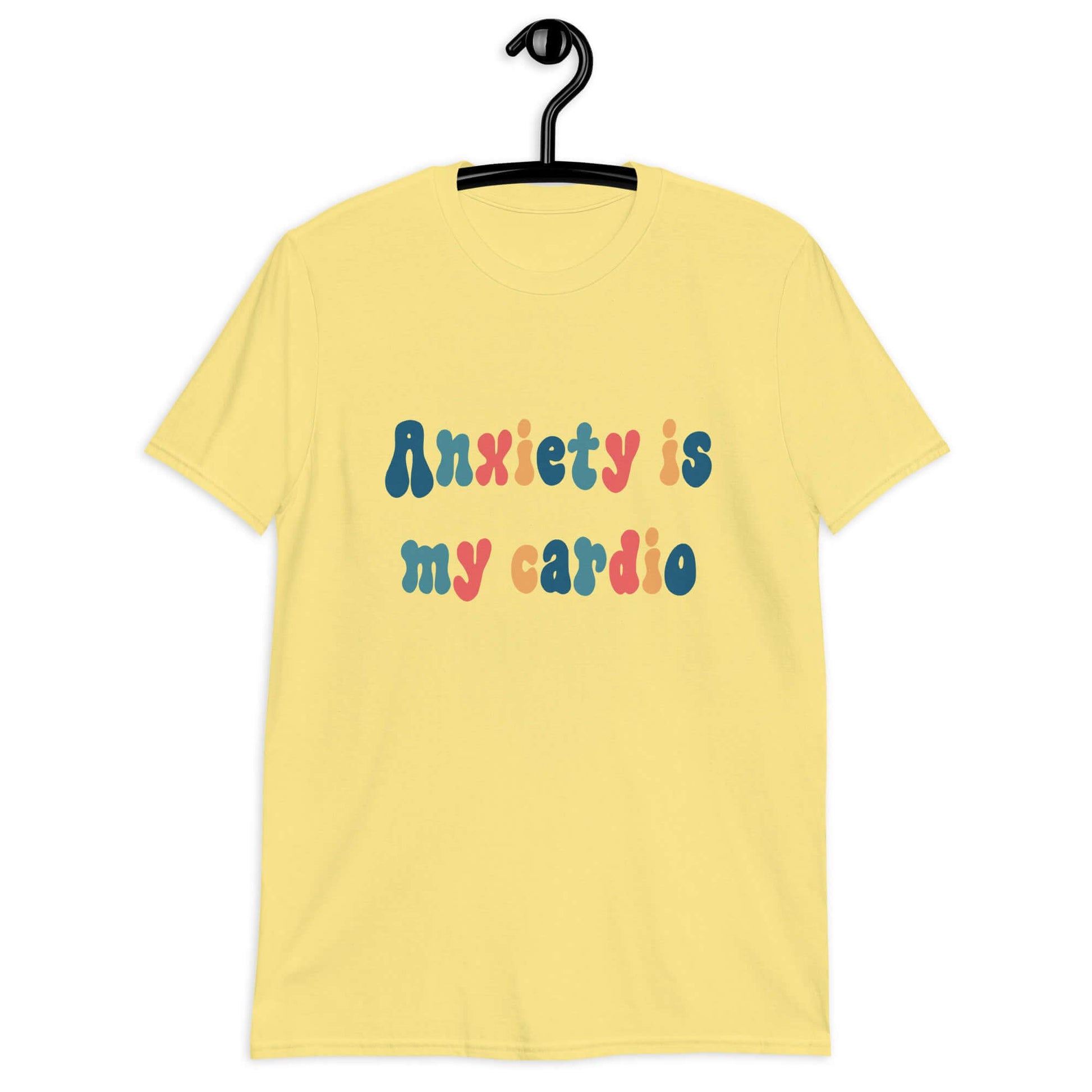 Cornsilk yellow t-shirt with the phrase Anxiety is my cardio printed in multiple colors on the front of the shirt.