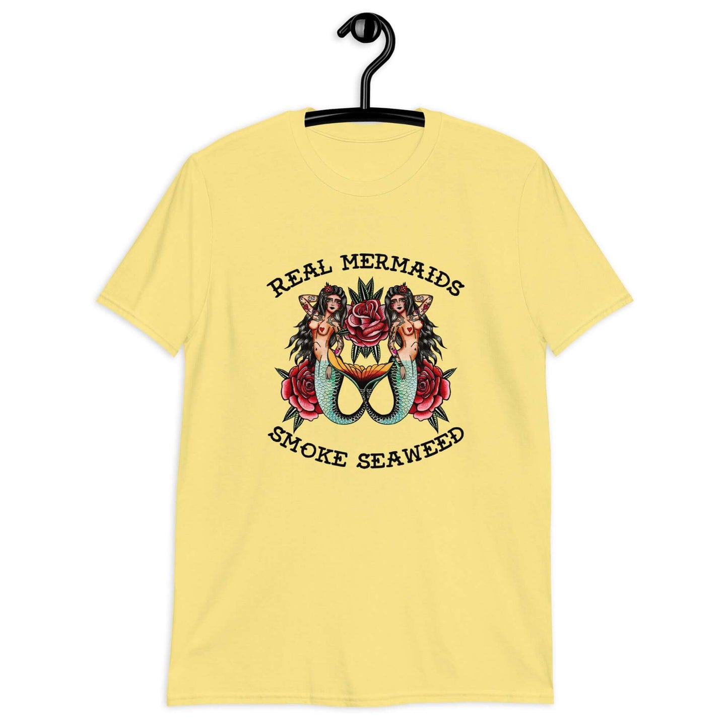 Cornsilk yellow t-shirt with image of 2 mermaids and the words Real mermaids smoke seaweed printed on the front.