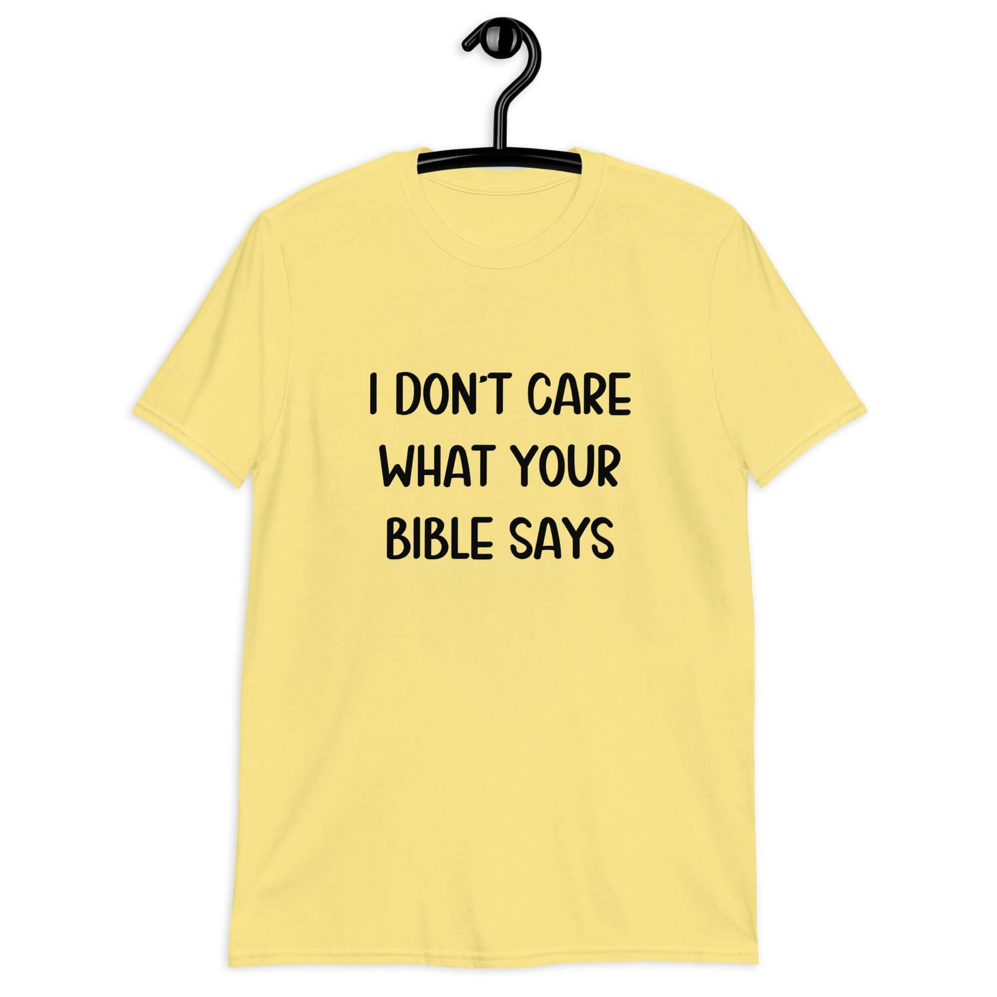 Cornsilk yellow t-shirt with the phrase I don't care what your bible says printed on the front.
