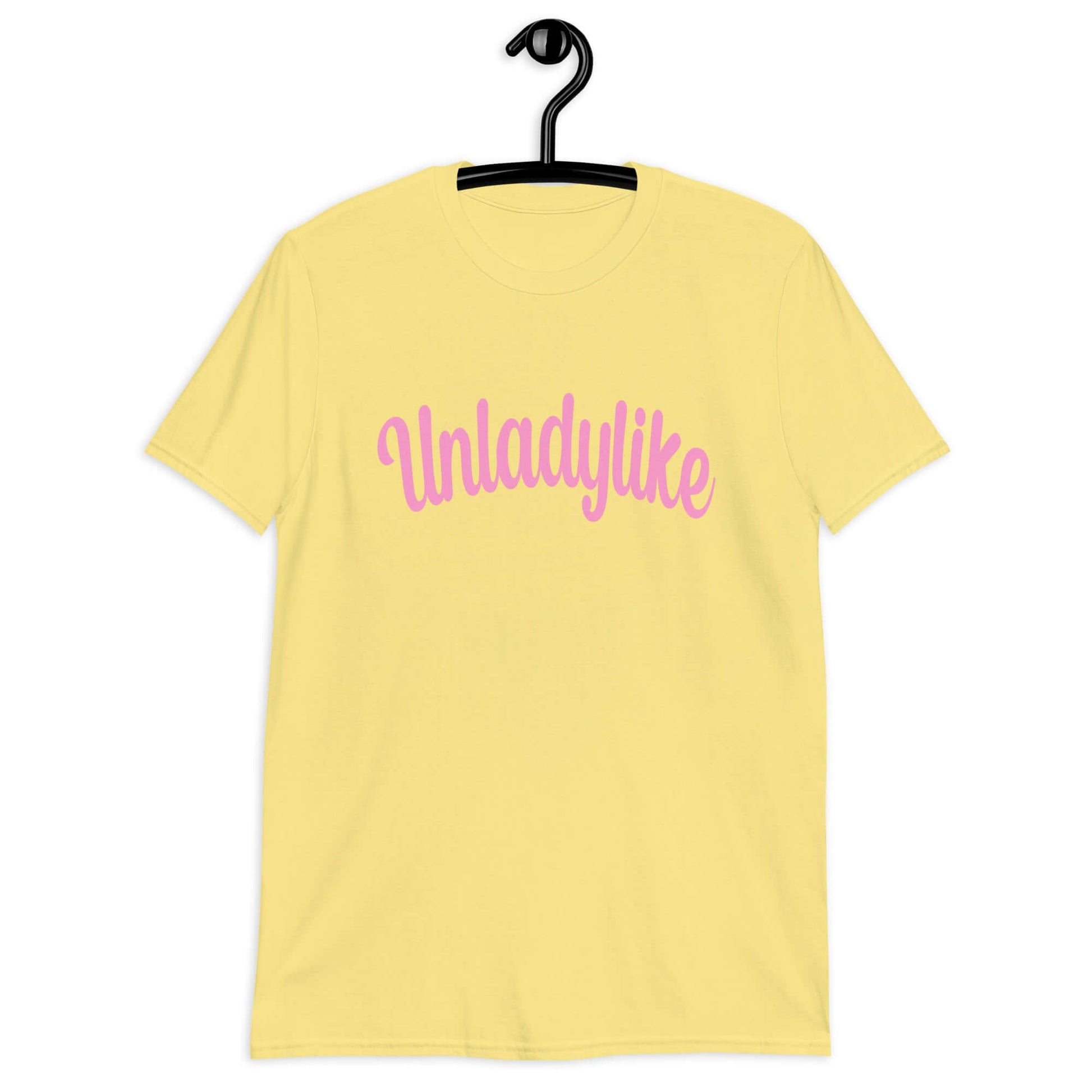 Cornsilk yellow t-shirt with the word Unladylike printed on the front in pink.