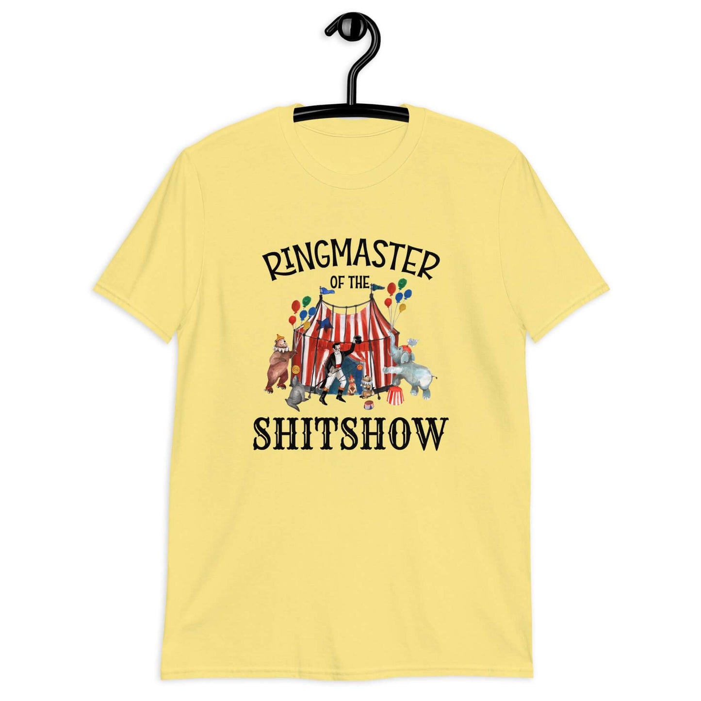Cornsilk yellow t-shirt with a circus theme graphic and the words Ringmaster of the Shitshow printed on the front.