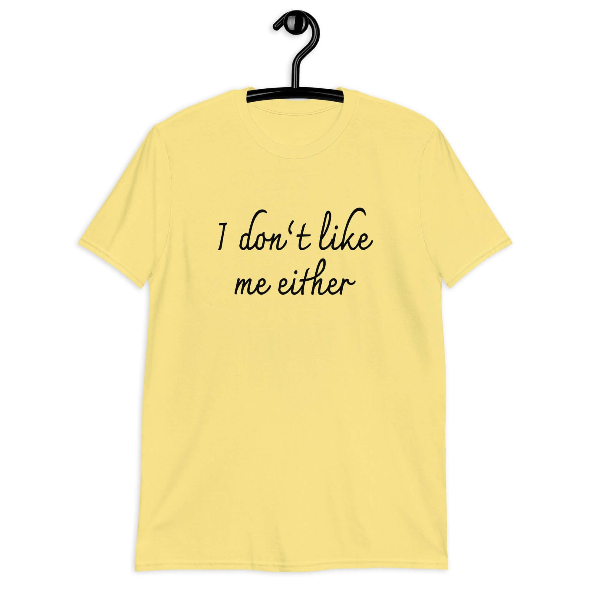 Cornsilk yellow t-shirt with the phrase I don't like me either printed on the front.