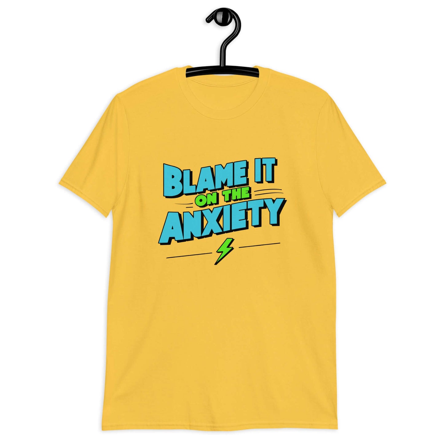 Daisy yellow t-shirt with the phrase Blame is on the anxiety printed on the front. The graphics are bold and in aqua and lime green.