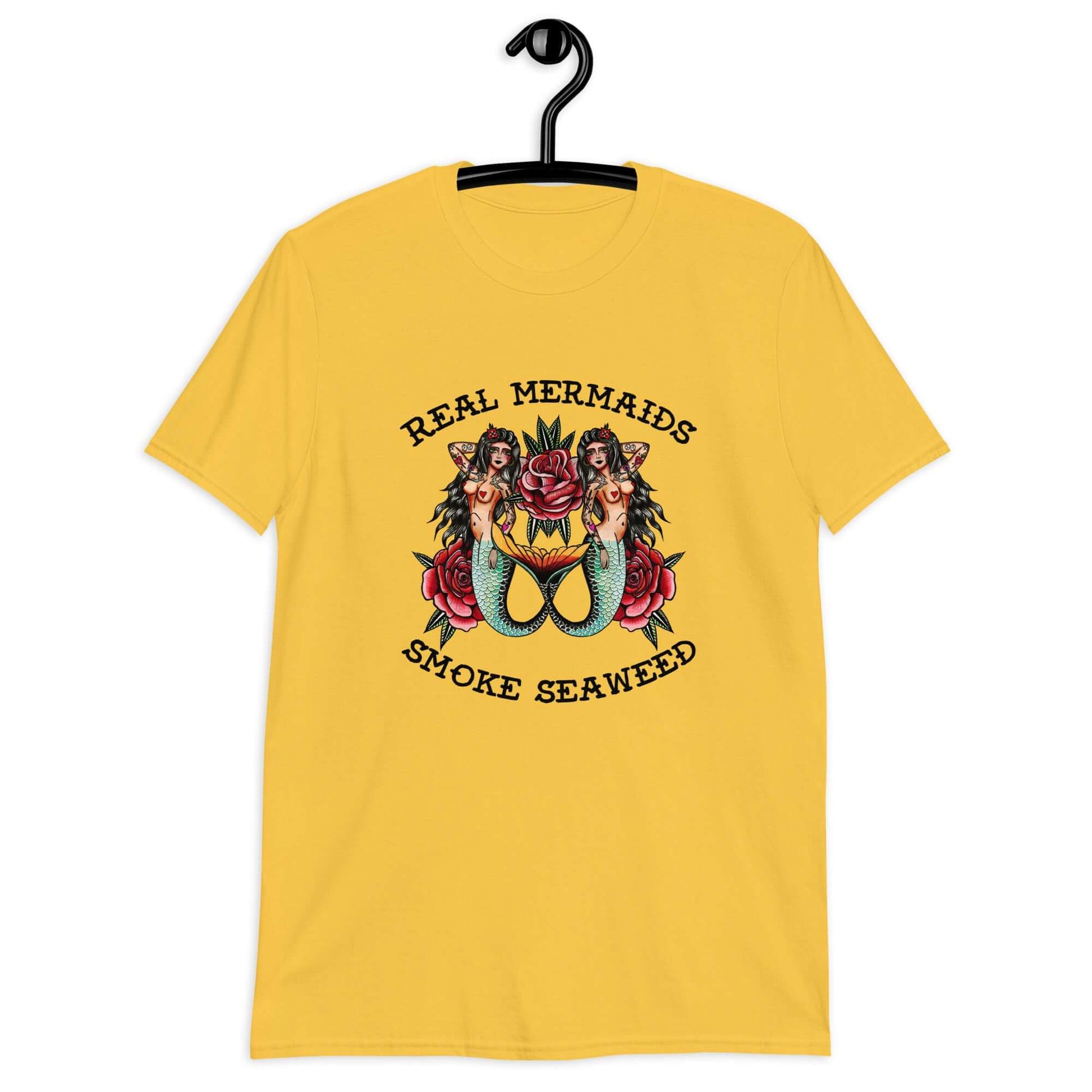 Daisy yellow t-shirt with image of 2 mermaids and the words Real mermaids smoke seaweed printed on the front.
