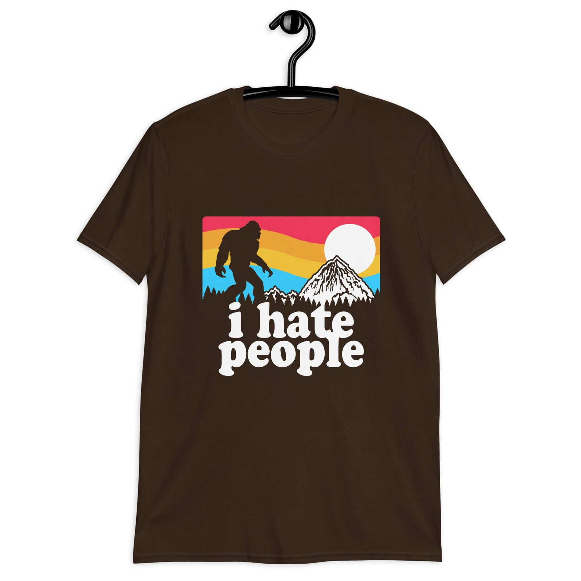 Dark chocolate brown t-shirt with a graphic of Bigfoot walking into the sunset with the words I hate people printed on the front.