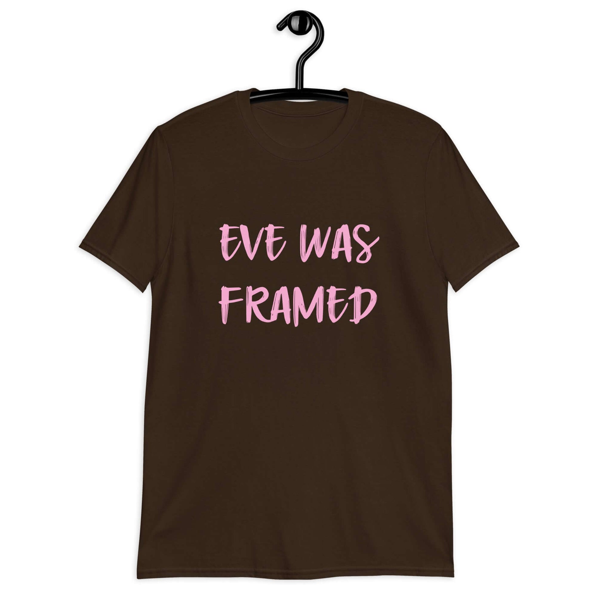 Dark chocolate brown t-shirt with the words Eve was framed printed on the front in pink.