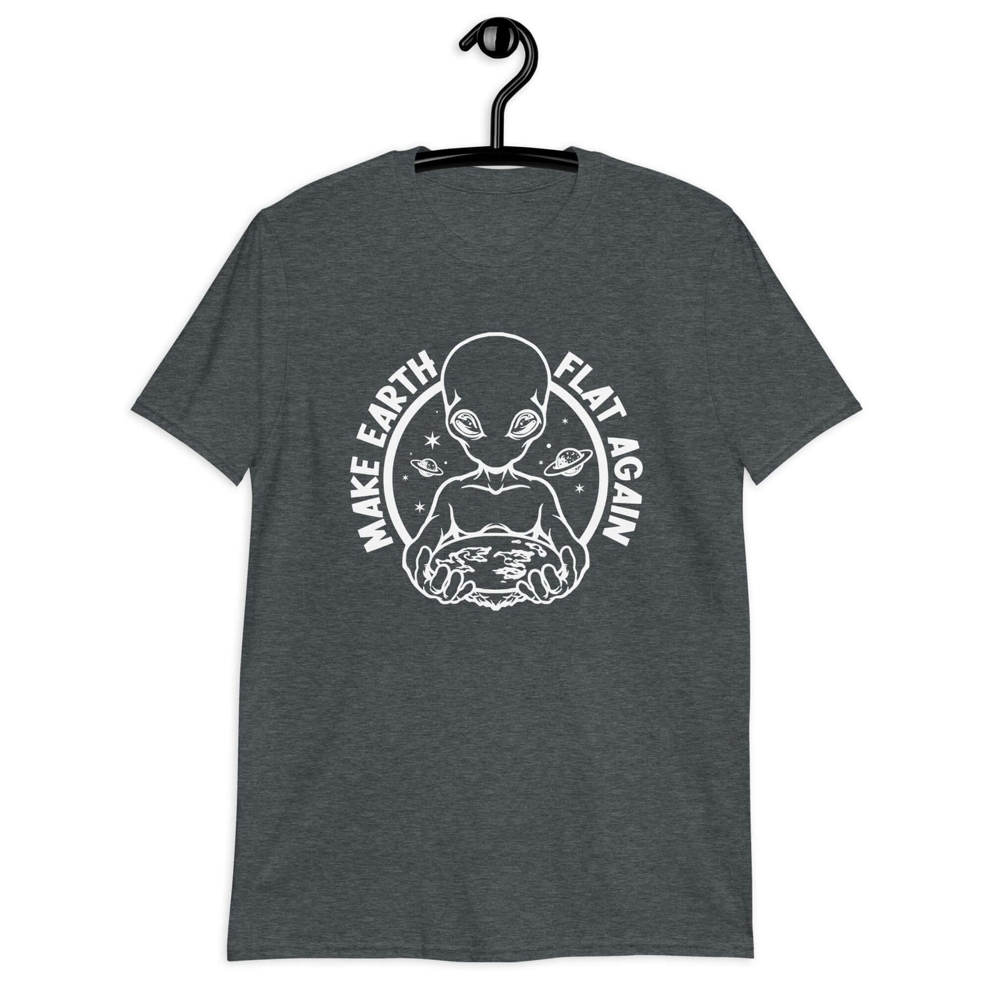 Dark heather grey t-shirt with an image of an alien holding flat earth and the phrase Make earth flat again printed on the front.