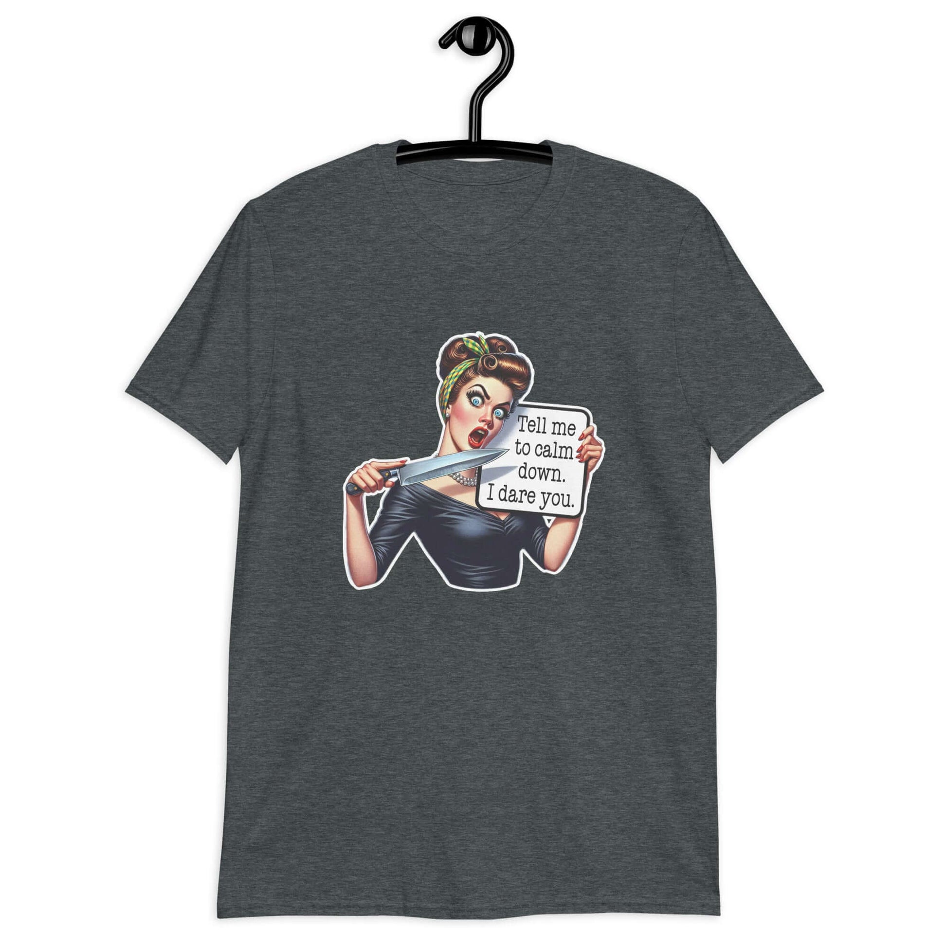 Dark heather grey t-shirt displayed on a hanger. The t-shirt has a graphic of an angry looking retro woman holding a knife and a sign. The sign says Tell me to calm down I dare you. The graphic is printed on the front of the shirt.