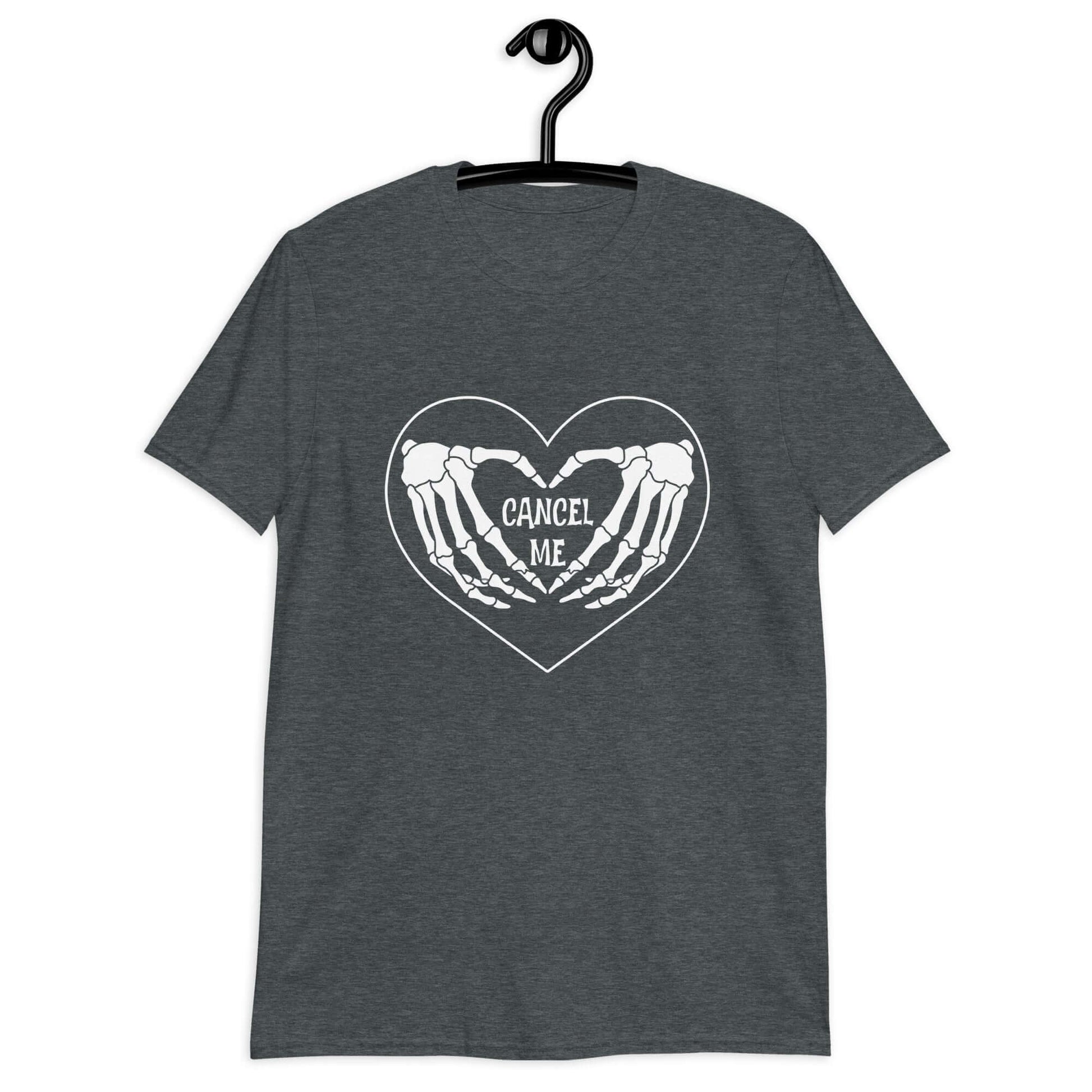 Dark heather grey t-shirt with a black heart and skeleton hands making a heart shape printed on the front. The words Cancel Me are inside of the heart.