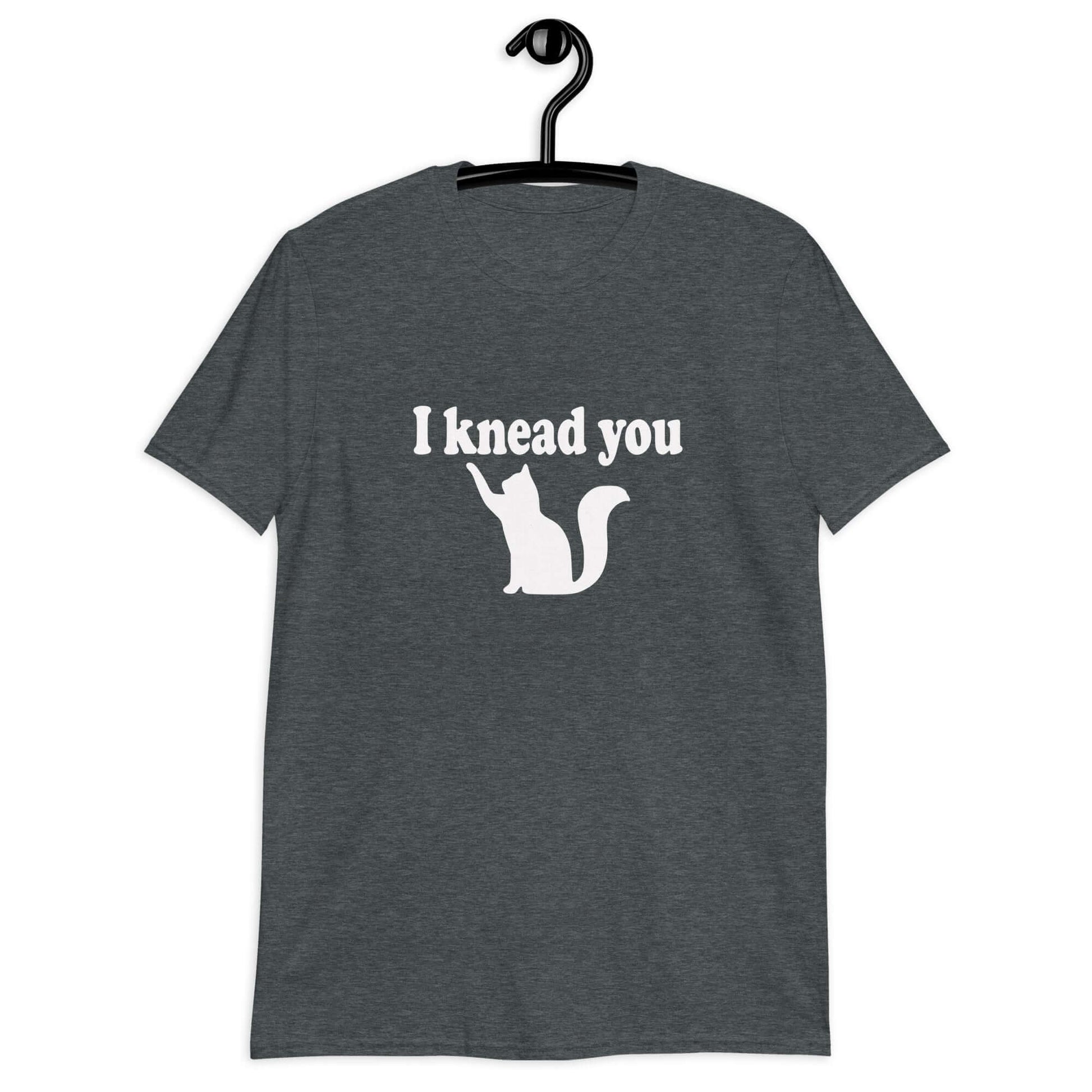 Dark heather t-shirt that has an image of a silhouette of a cat and the words I knead you printed on the front.
