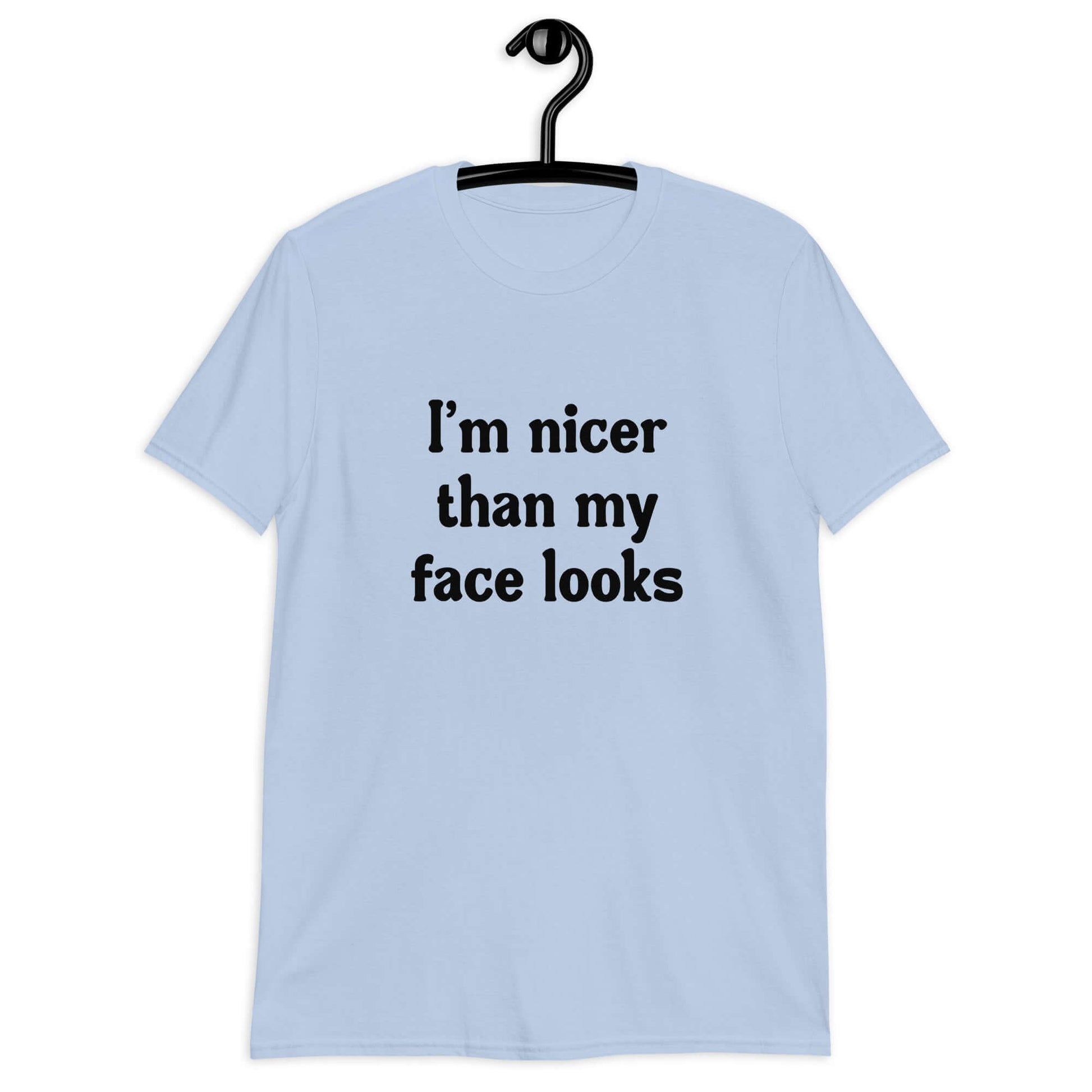 Light blue t-shirt with the phrase I'm nicer than my face looks printed on the front.