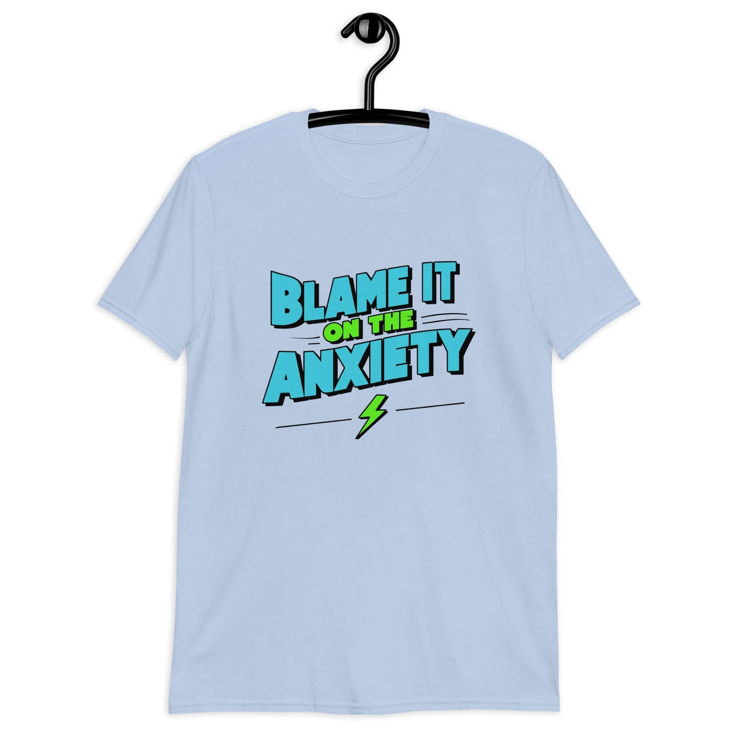 Light blue t-shirt with the phrase Blame is on the anxiety printed on the front. The graphics are bold and in aqua and lime green.