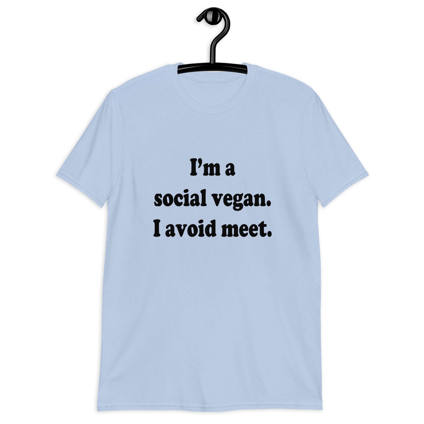 Light blue t-shirt with the pun phrase I'm a social vegan, I avoid meet printed on the front.