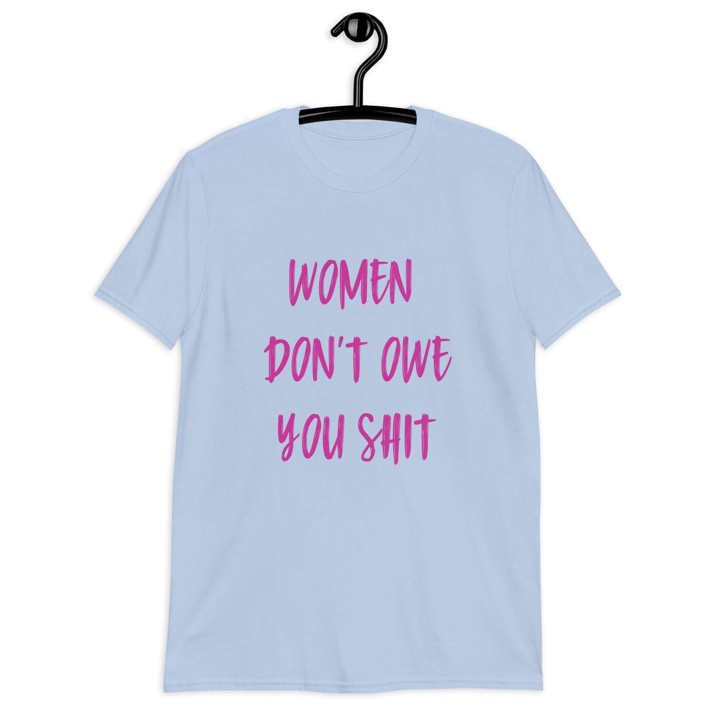 Light blue t-shirt with the words Women don't owe you shit printed on the front in pink.