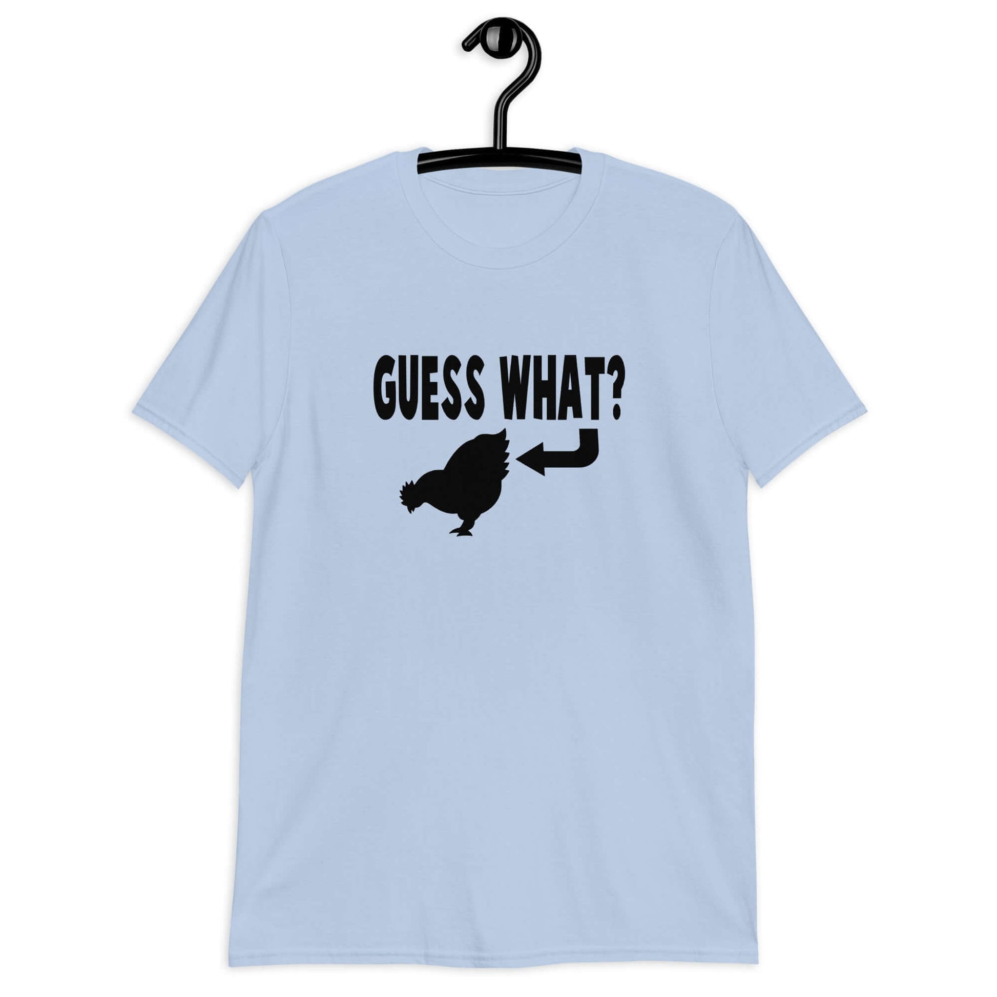 Light blue t-shirt with an image of a chicken and the words Guess what question mark. There is an arrow pointing to the chickens butt. The graphics are printed on the front of the shirt.