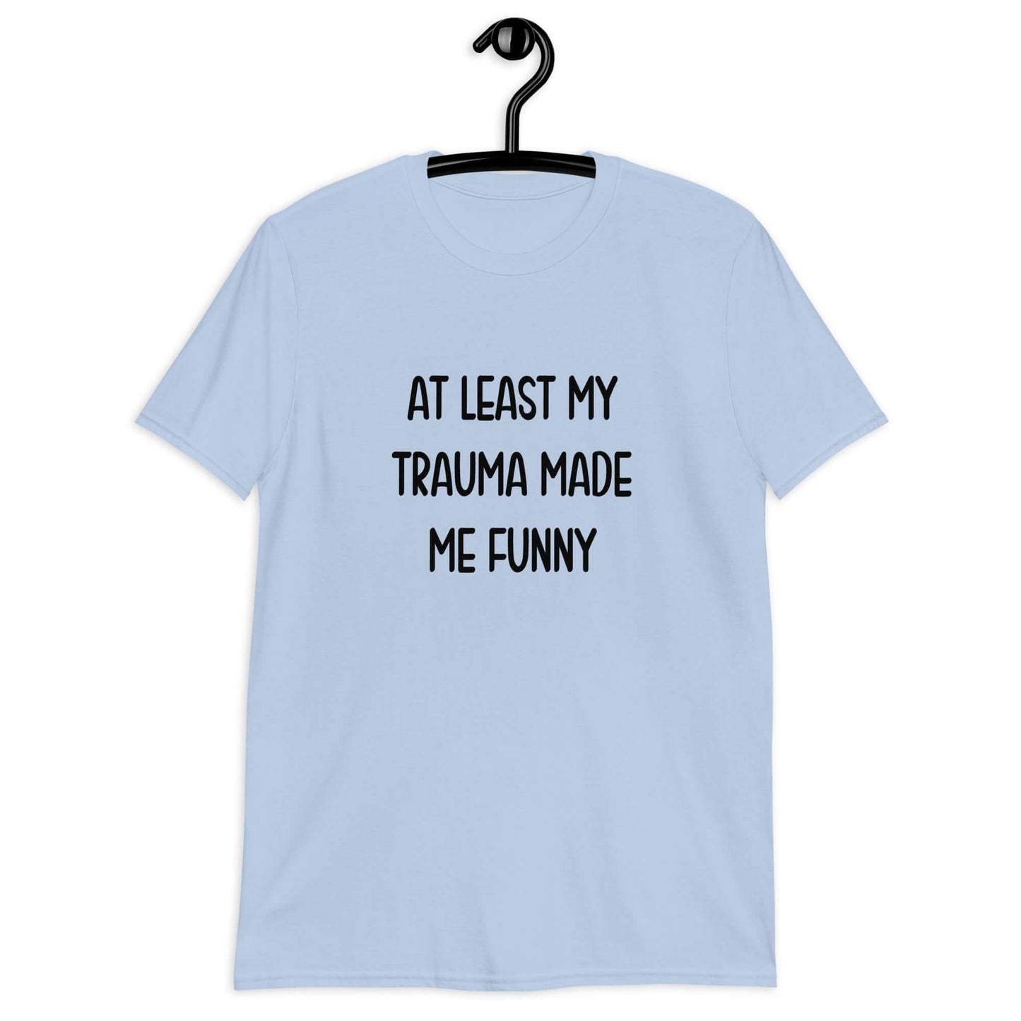 Light blue t-shirt with the words At least my trauma made me funny printed on the front.