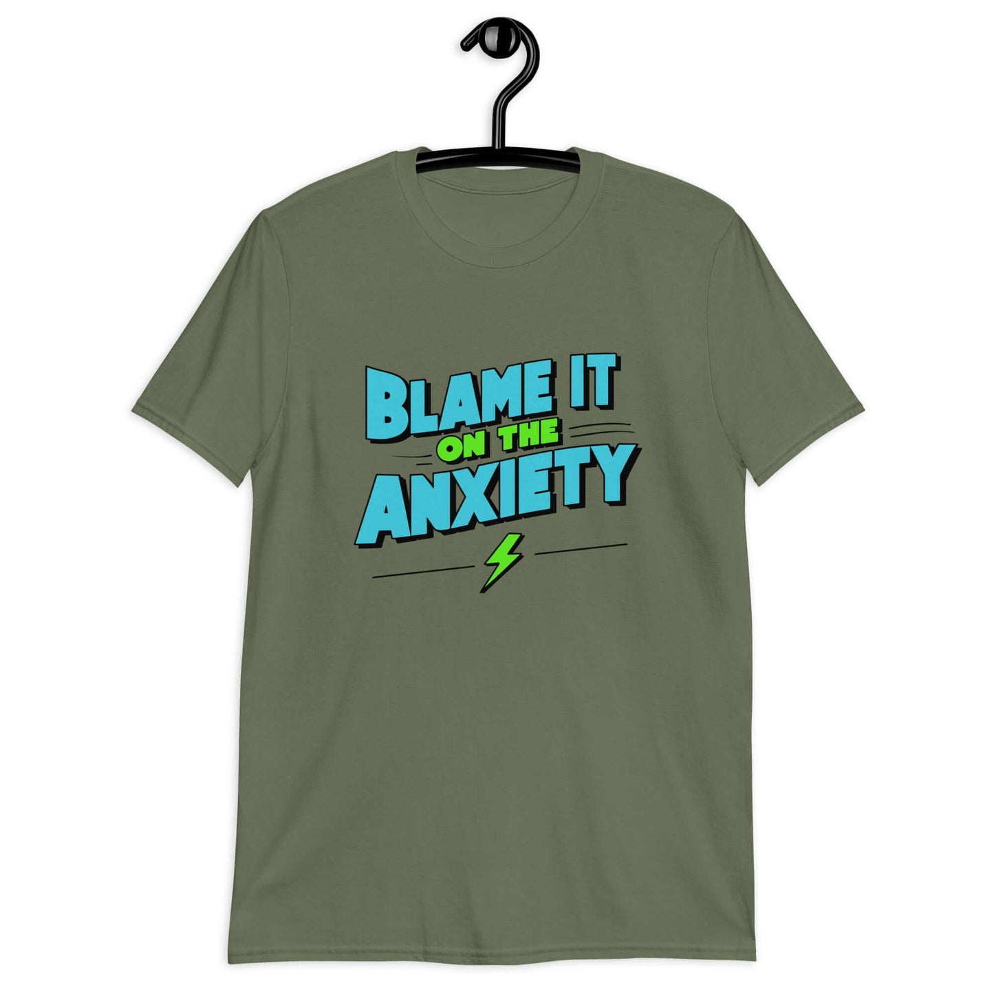 Military green t-shirt with the phrase Blame is on the anxiety printed on the front. The graphics are bold and in aqua and lime green.