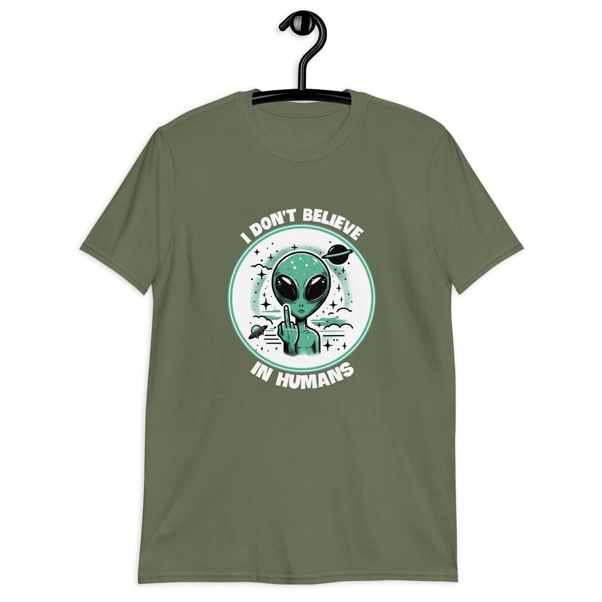 Military green t-shirt with an image of an alien flipping the middle finger. The words I don't believe in humans are printed around the image. The graphics are printed on the front of the shirt.