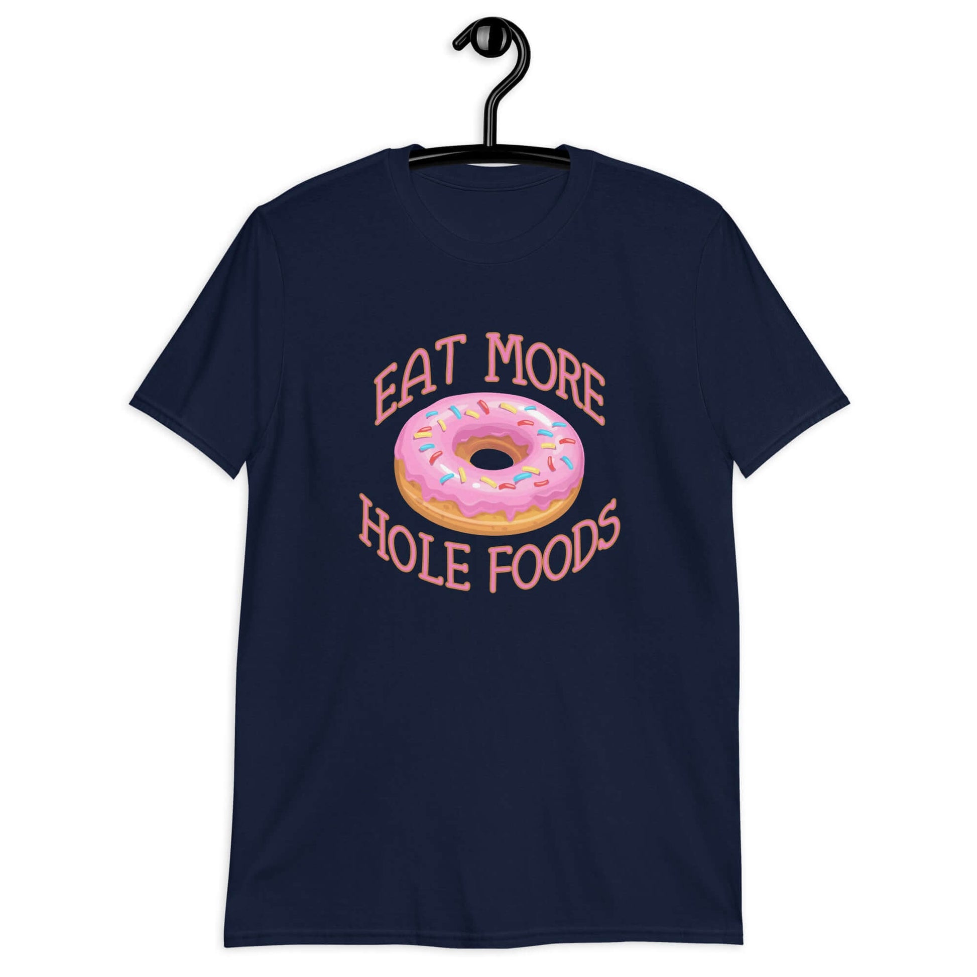 Navy blue t-shirt that has an image of a donut with pink icing and sprinkles and Eat more hole foods printed on the front.