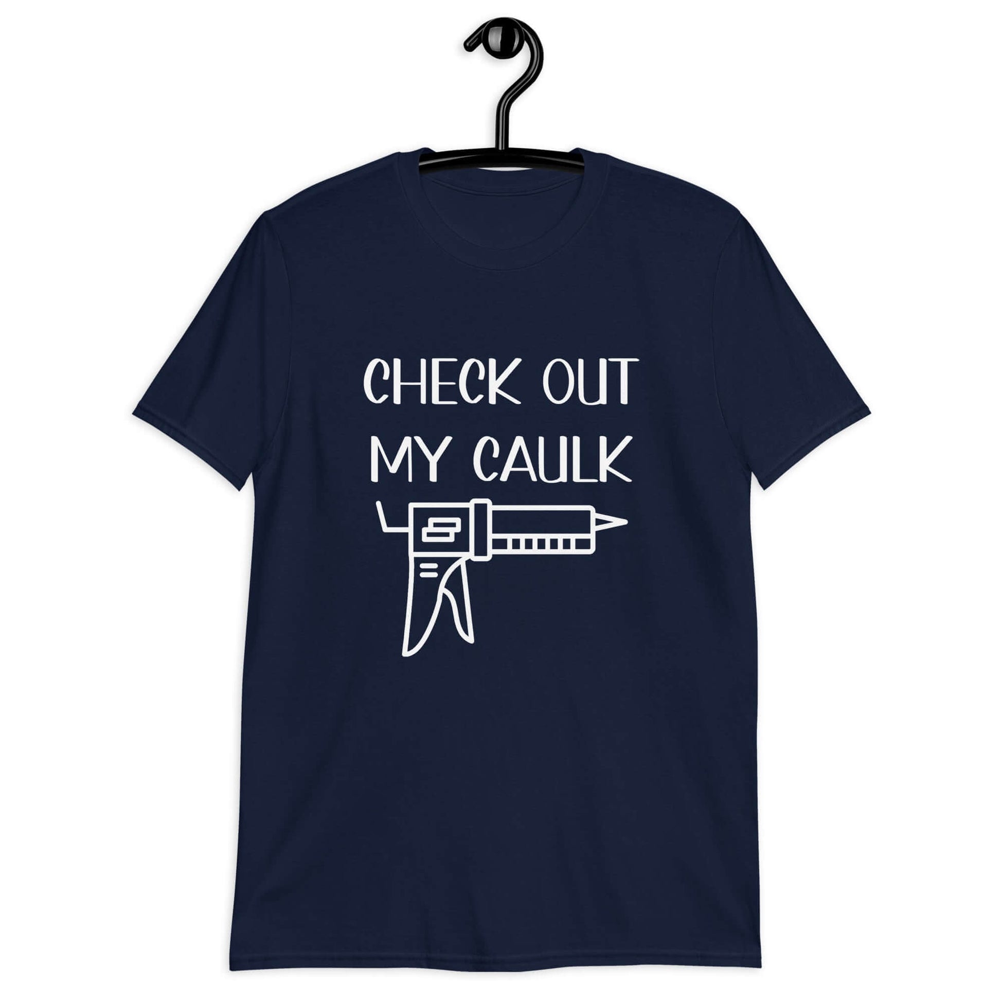 Navy blue t-shirt with the pun phrase Check out my caulk with a line drawing image of a caulking gun printed on the front.