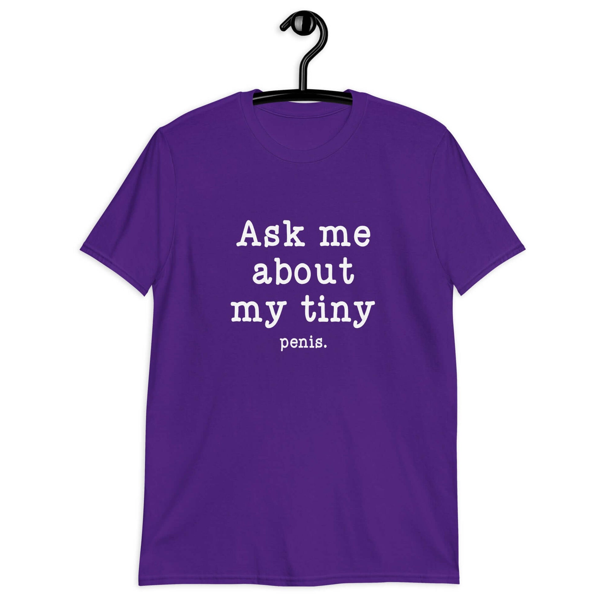 Purple t-shirt with the phrase Ask me about my tiny penis printed on the front. The word tiny is much smaller than the rest of the text.