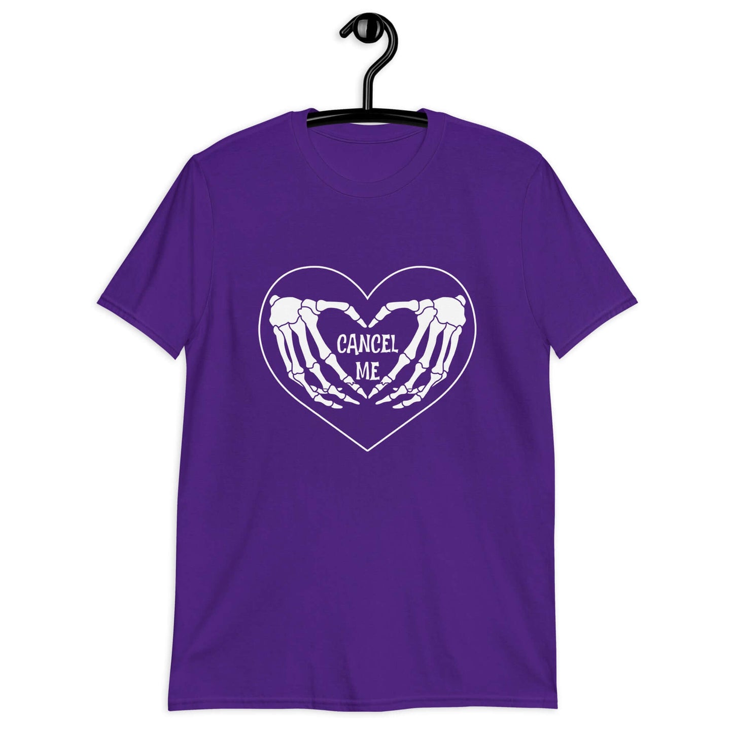 Purple t-shirt with a black heart and skeleton hands making a heart shape printed on the front. The words Cancel Me are inside of the heart.