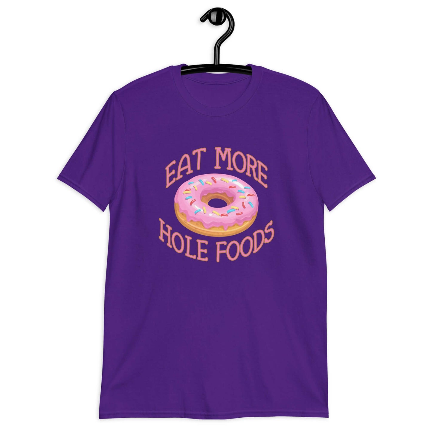 Purple t-shirt that has an image of a donut with pink icing and sprinkles and Eat more hole foods printed on the front.