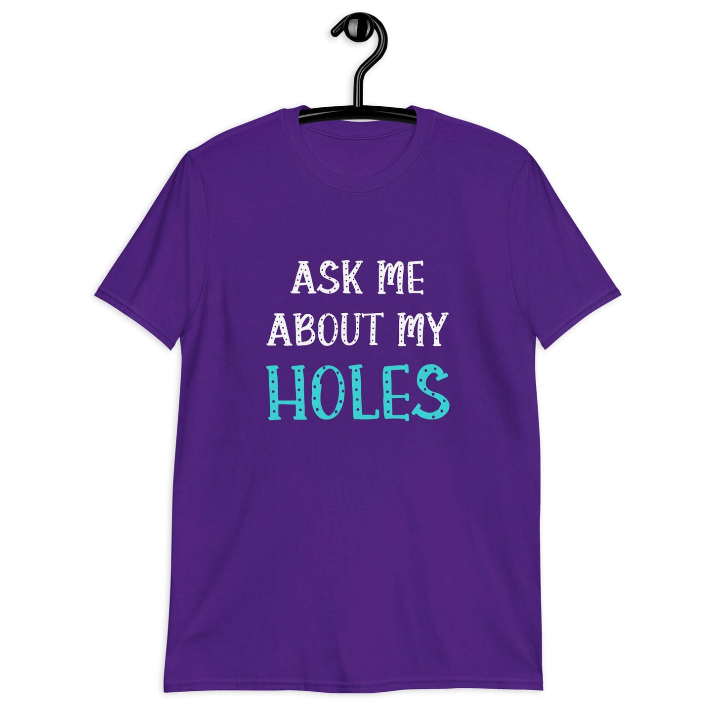 Purple t-shirt with the words Ask me about my holes printed on the front. The word holes in turquoise color and the rest of the text is white.