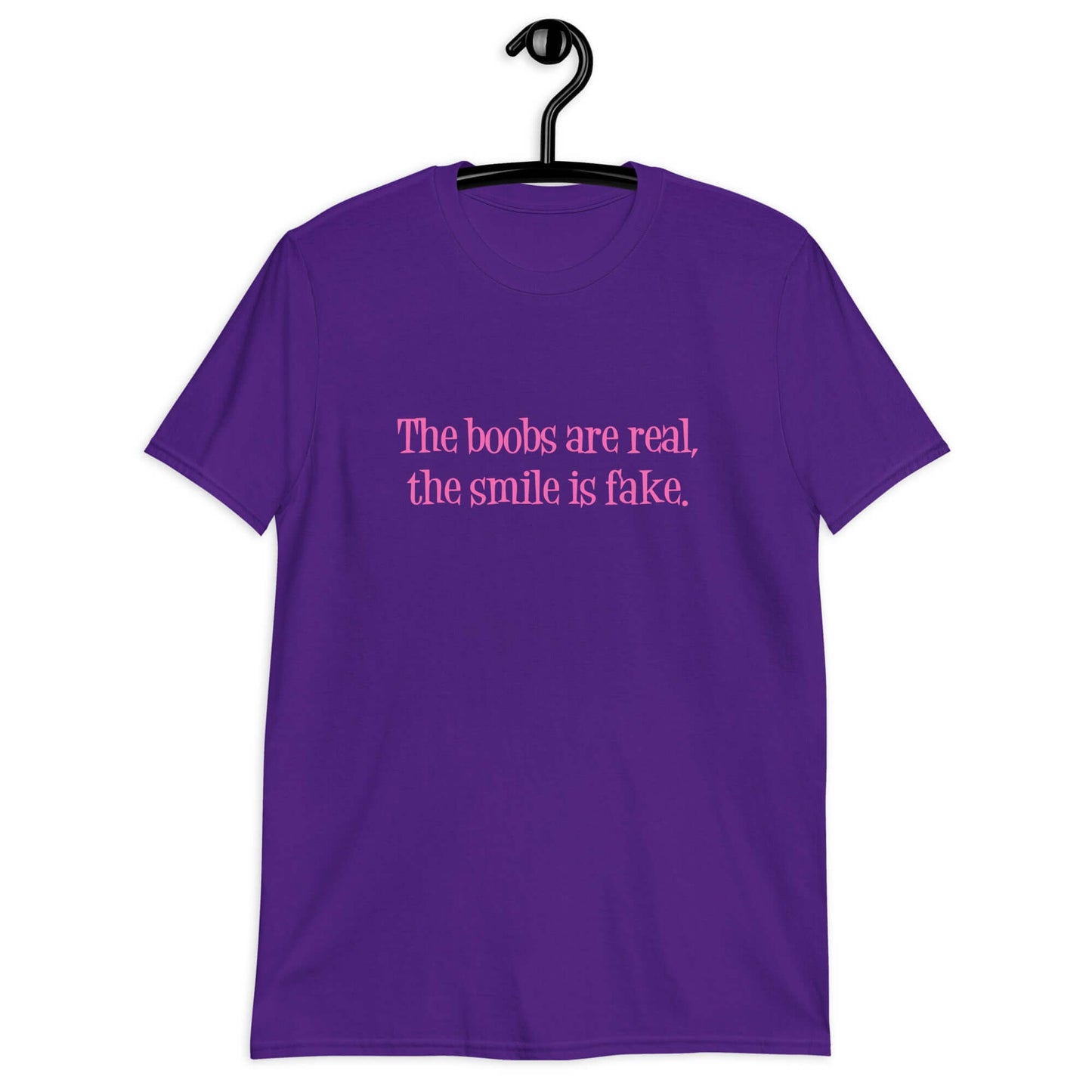 Purple t-shirt with the phrase The boobs are real, the smile is fake printed in pink on the front.