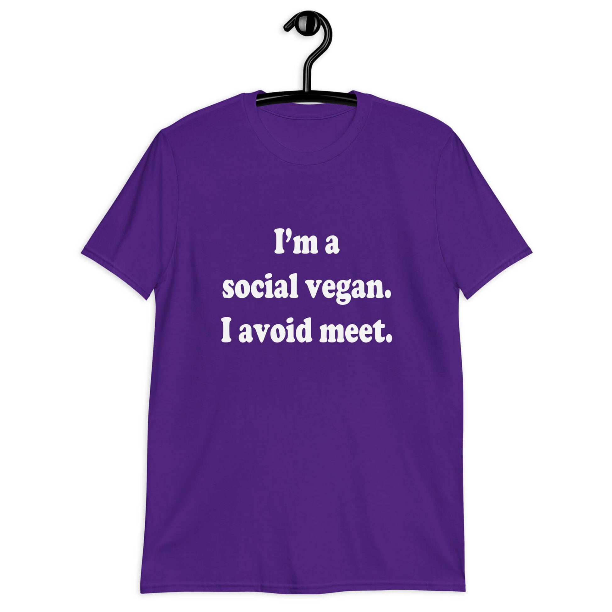 Purple t-shirt with the pun phrase I'm a social vegan, I avoid meet printed on the front.