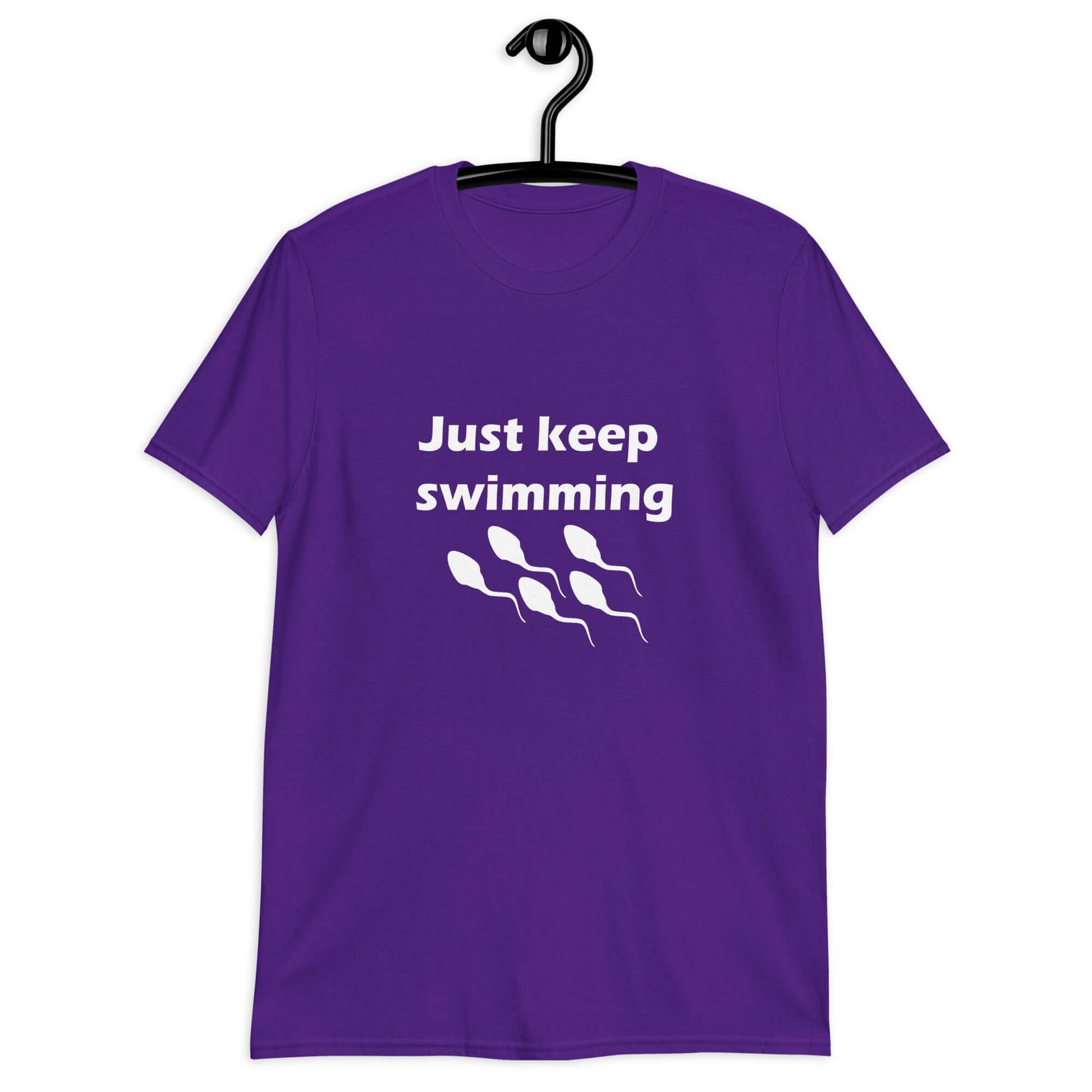 Purple t-shirt with the phrase Just keep swimming printed on the front. There is an image of some swimming sperm underneath the words.