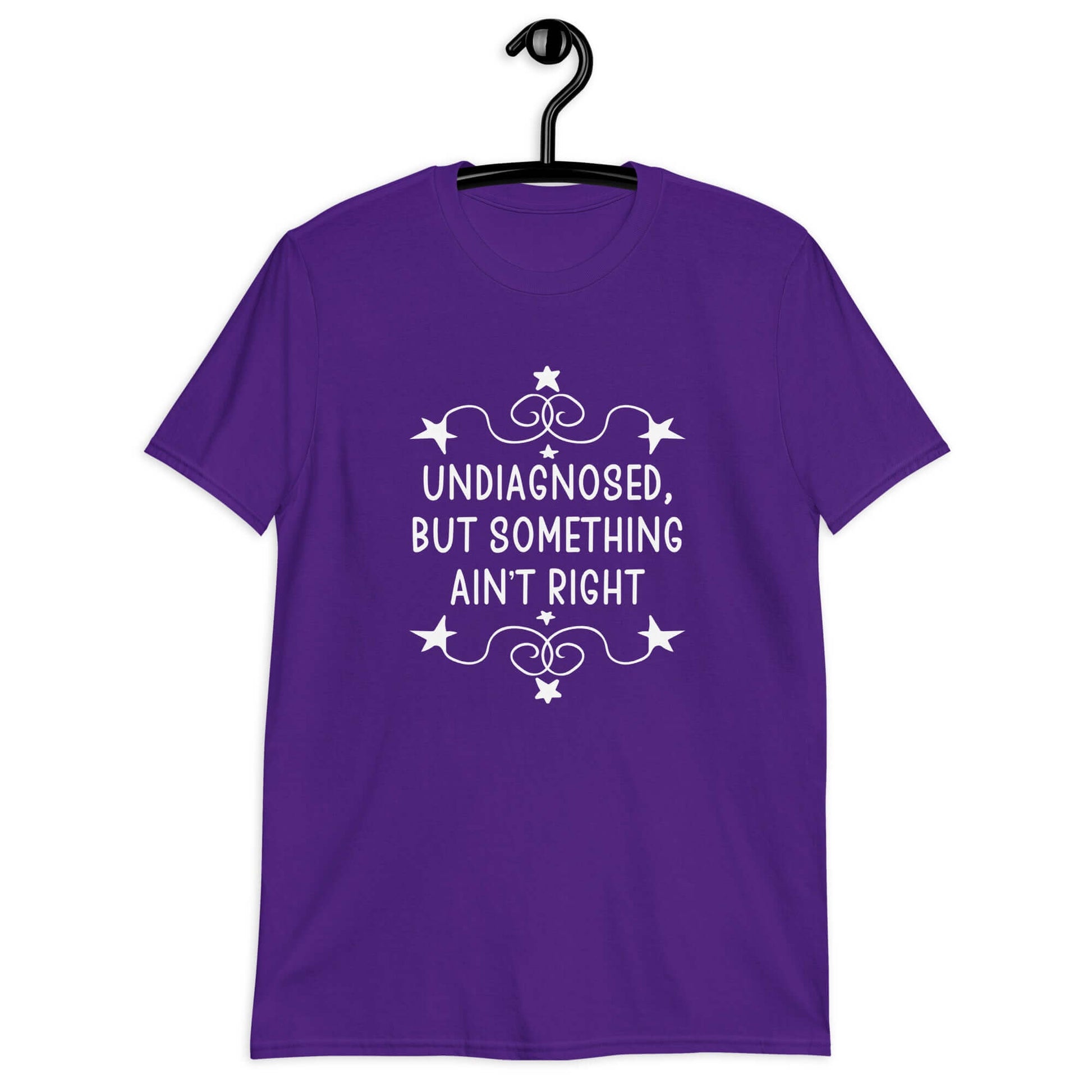 Purple t-shirt with the phrase Undiagnosed, but something ain't right printed on the front. The text is white and has a star graphic embellishment around the words.