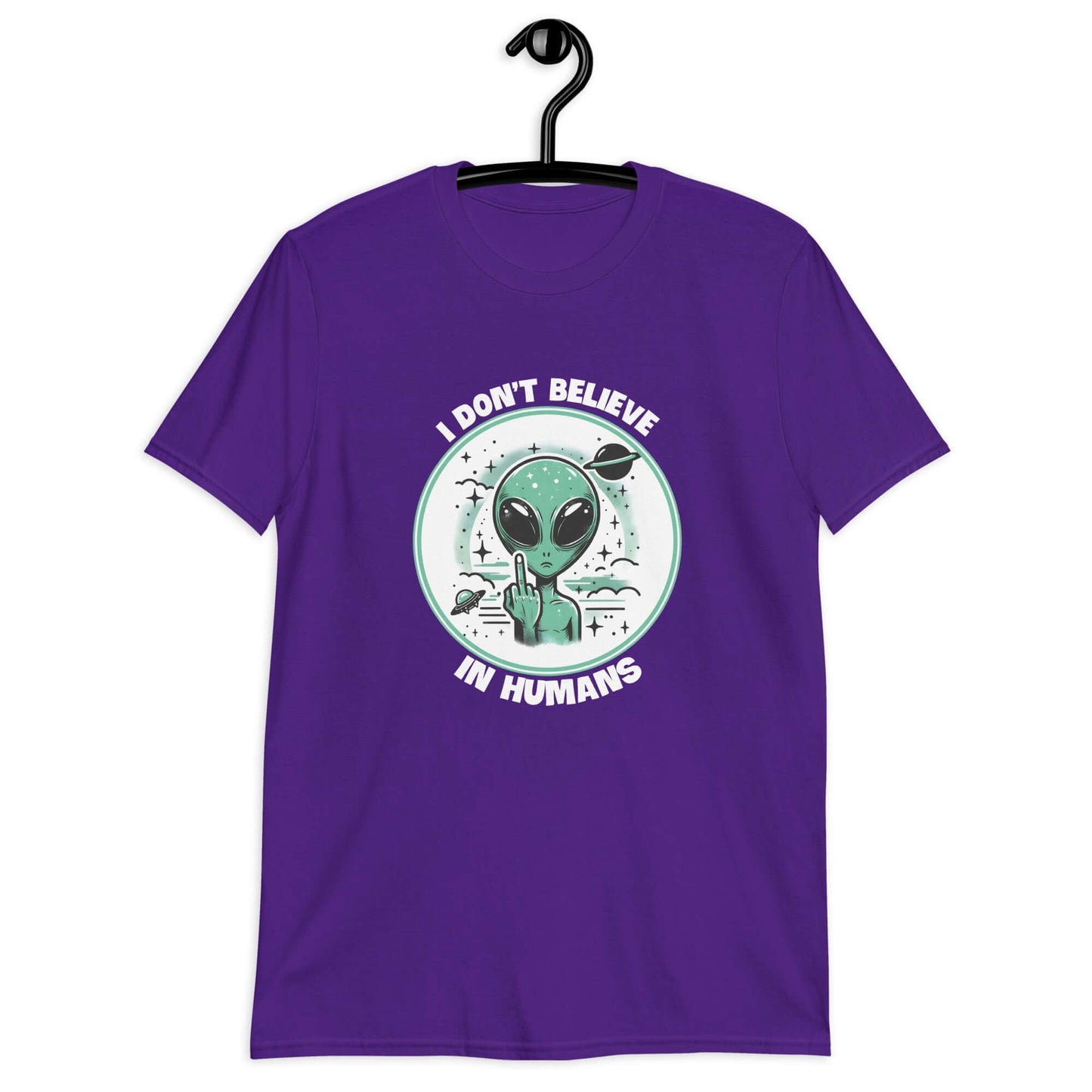 Purple t-shirt with an image of an alien flipping the middle finger. The words I don't believe in humans are printed around the image. The graphics are printed on the front of the shirt.