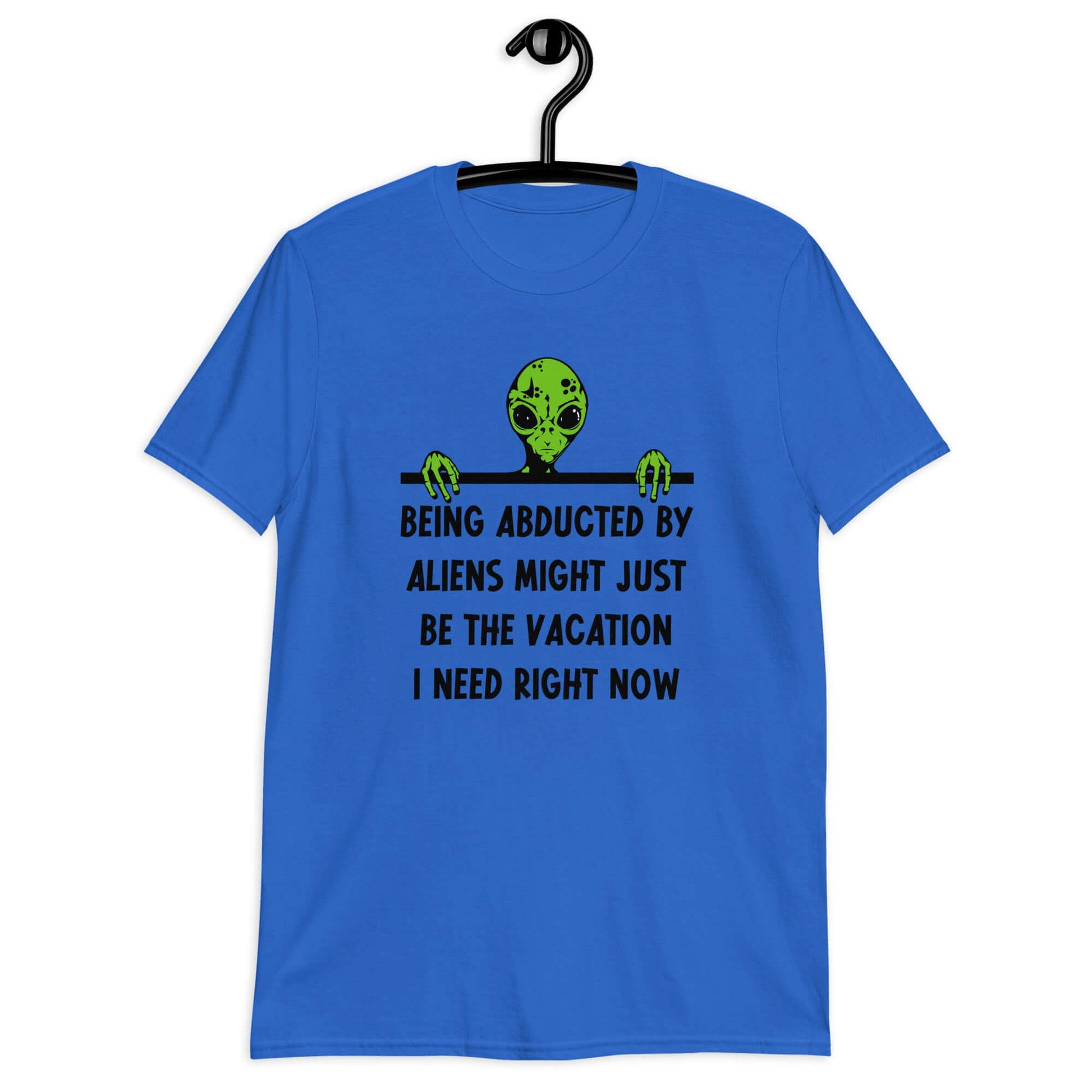 Royal blue t-shirt with an image of a green alien and the phrase Being abducted by aliens might just be the vacation I need right now printed on the front of the shirt.