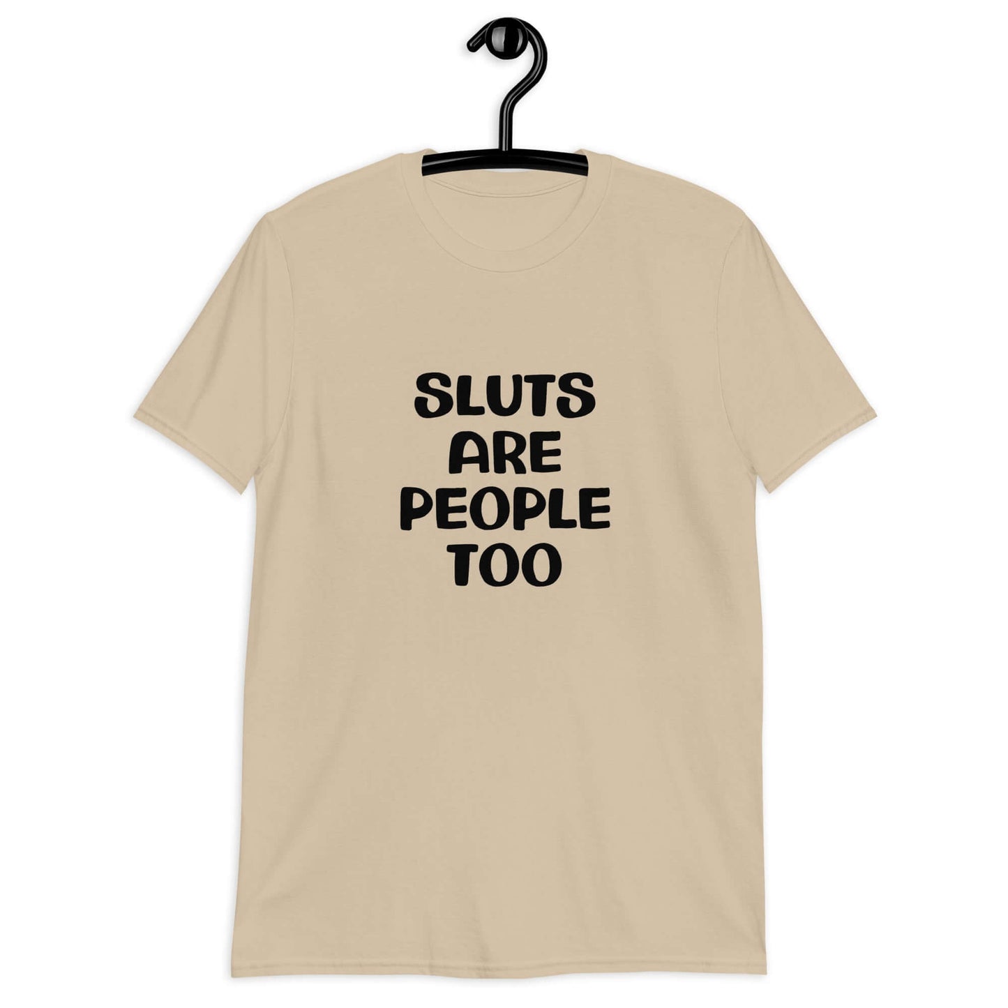 Sand color t-shirt with the phrase Sluts are people too printed on the front.