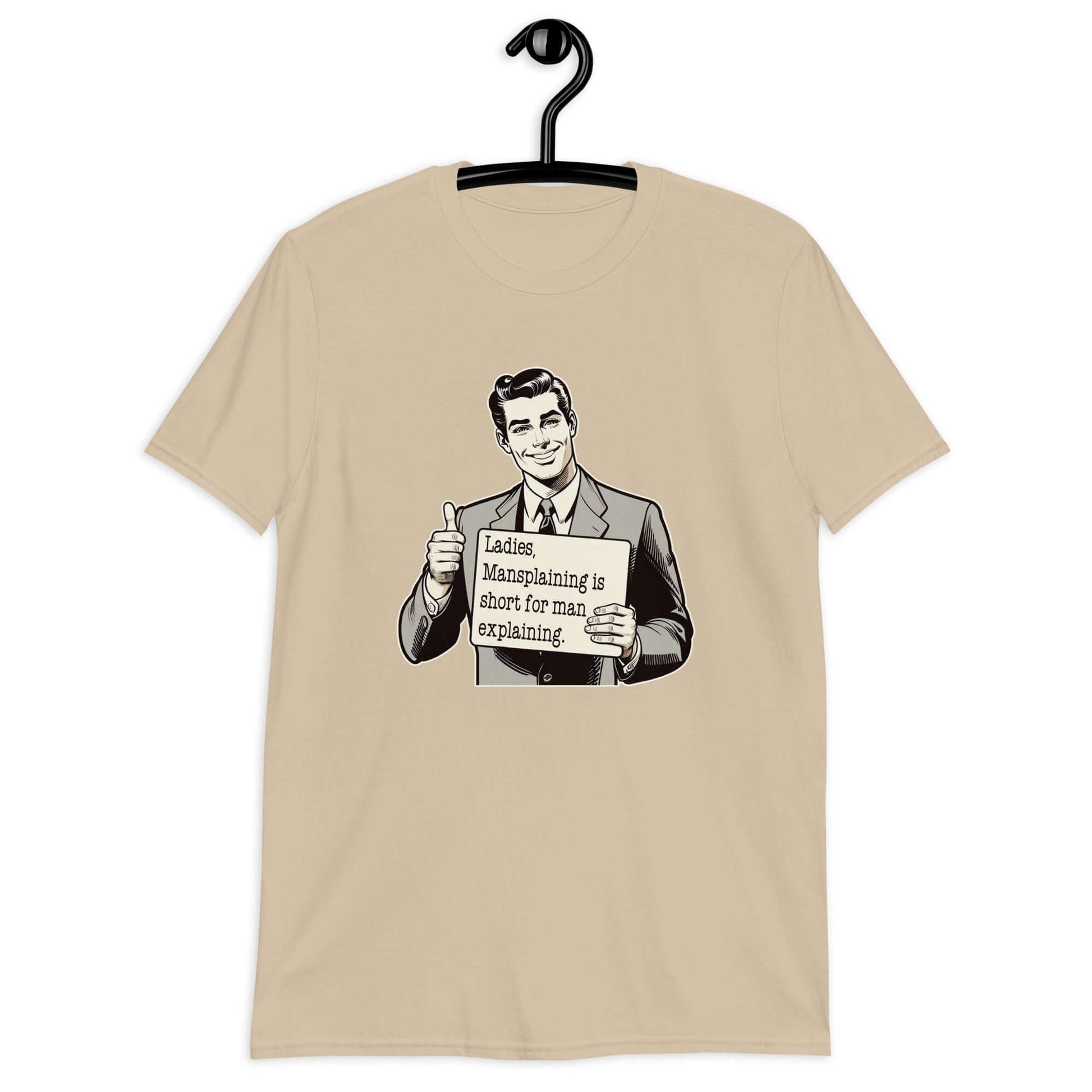 Sand color t-shirt with a graphic of a retro man holding a sign. The sign says Ladies, mansplaining is short for man explaining. The graphics are printed on the front of the shirt.