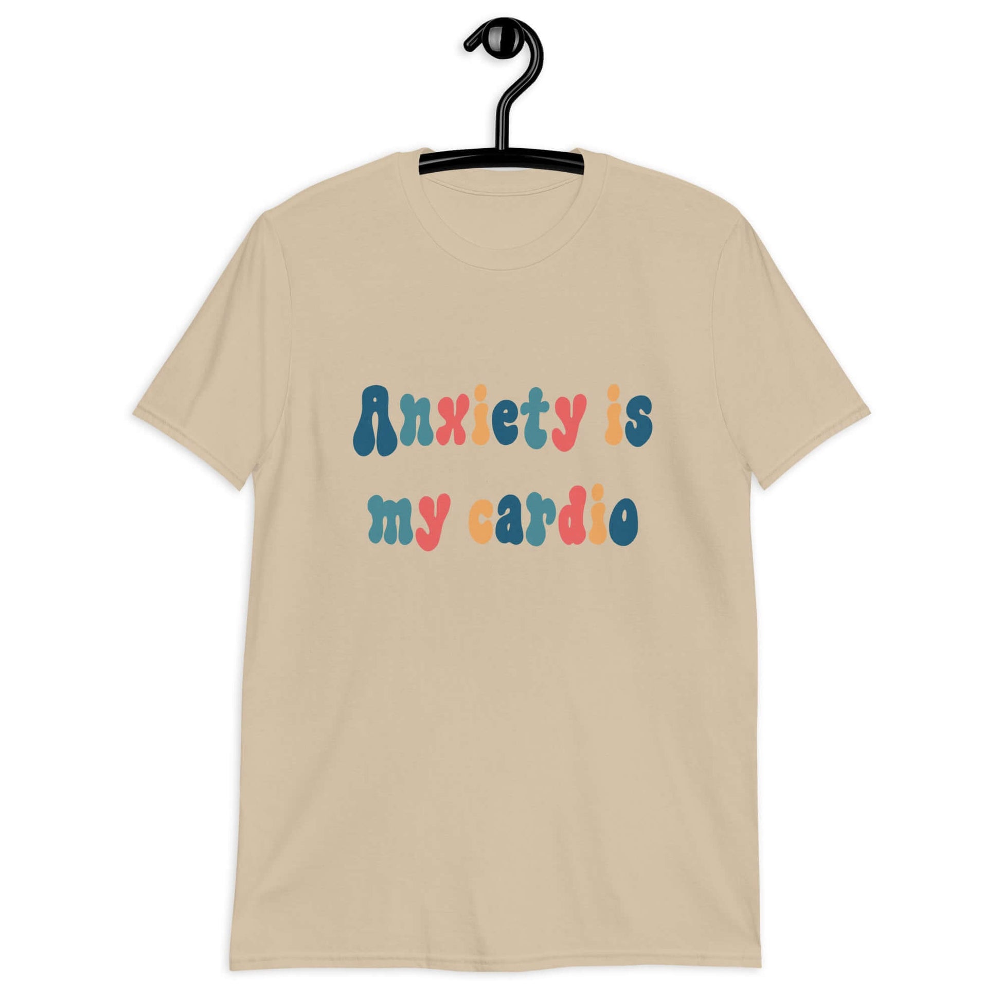 Sand t-shirt with the phrase Anxiety is my cardio printed in multiple colors on the front of the shirt.