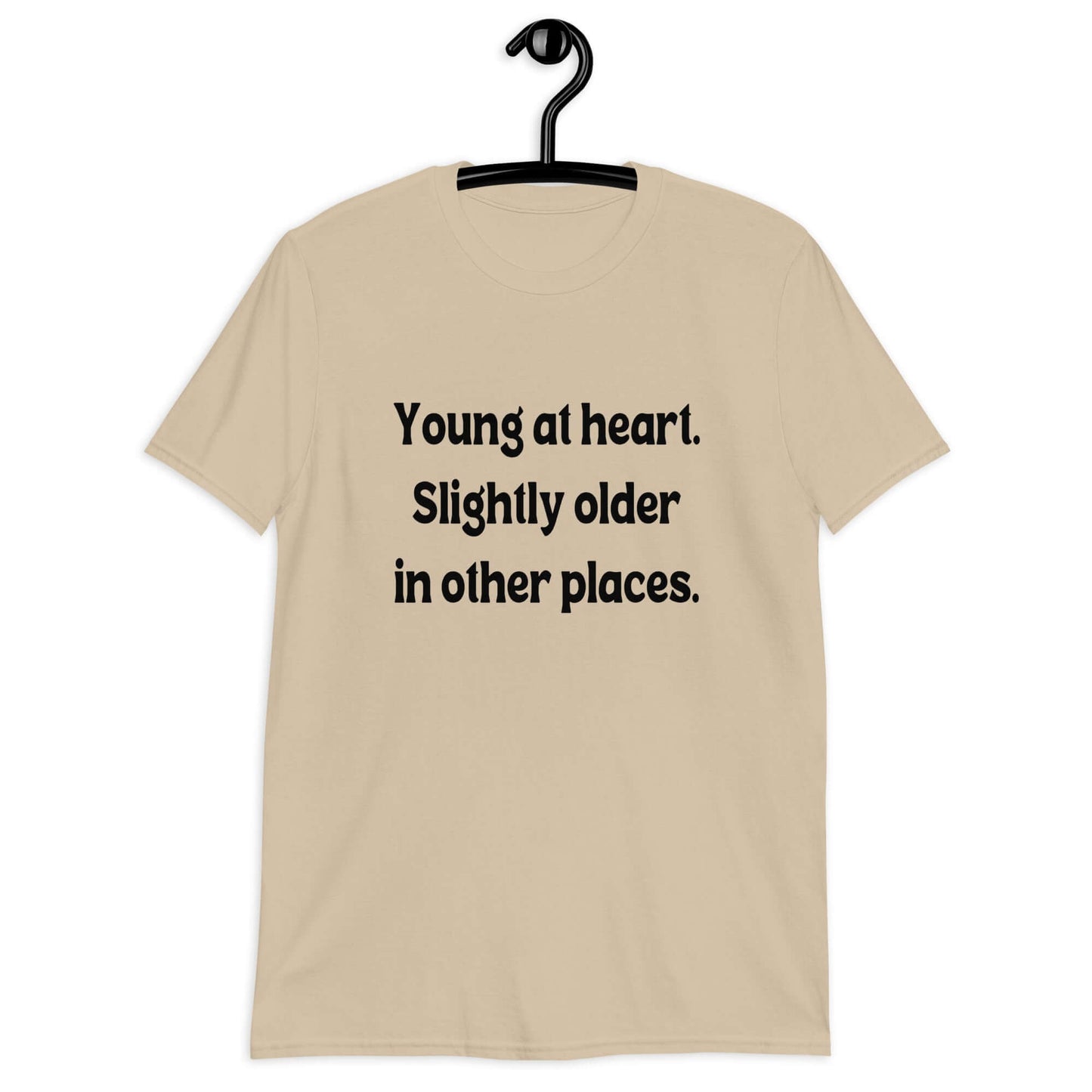 Sand t-shirt with the words Young at heart, slightly older in other places printed on the front.