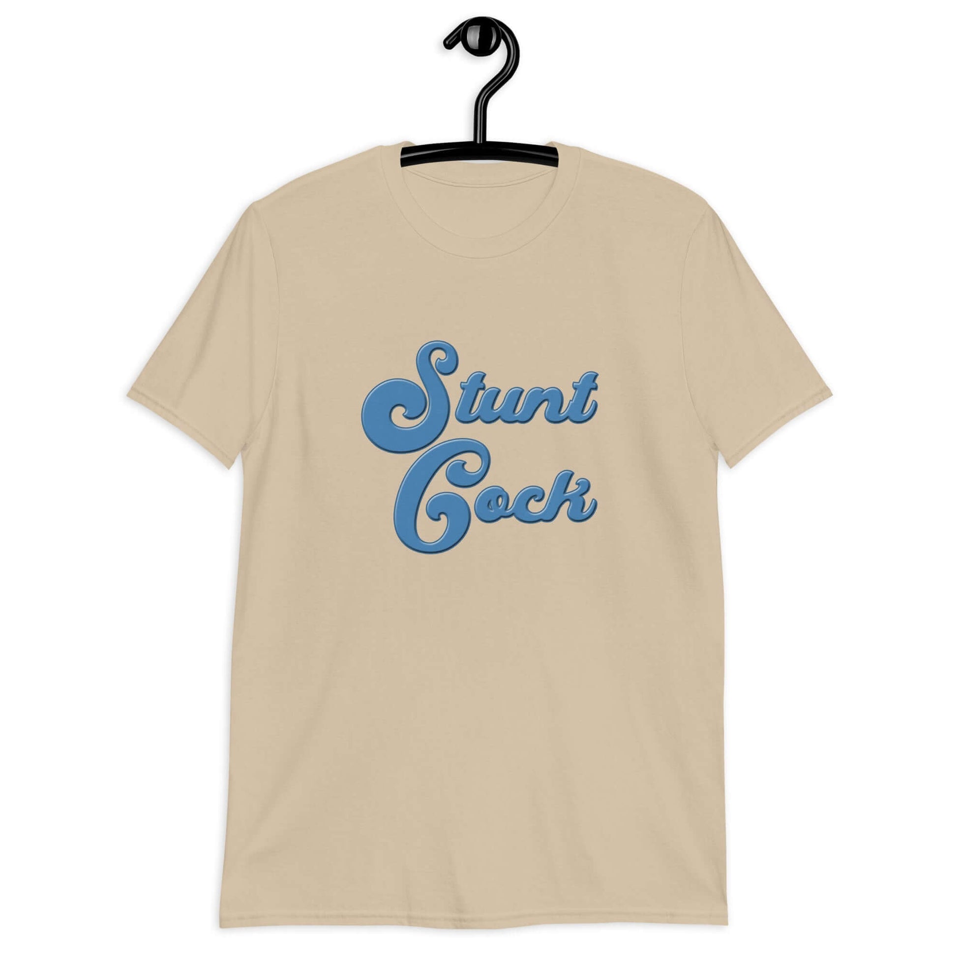 Sand color t-shirt with the words Stunt Cock printed on the front in blue.