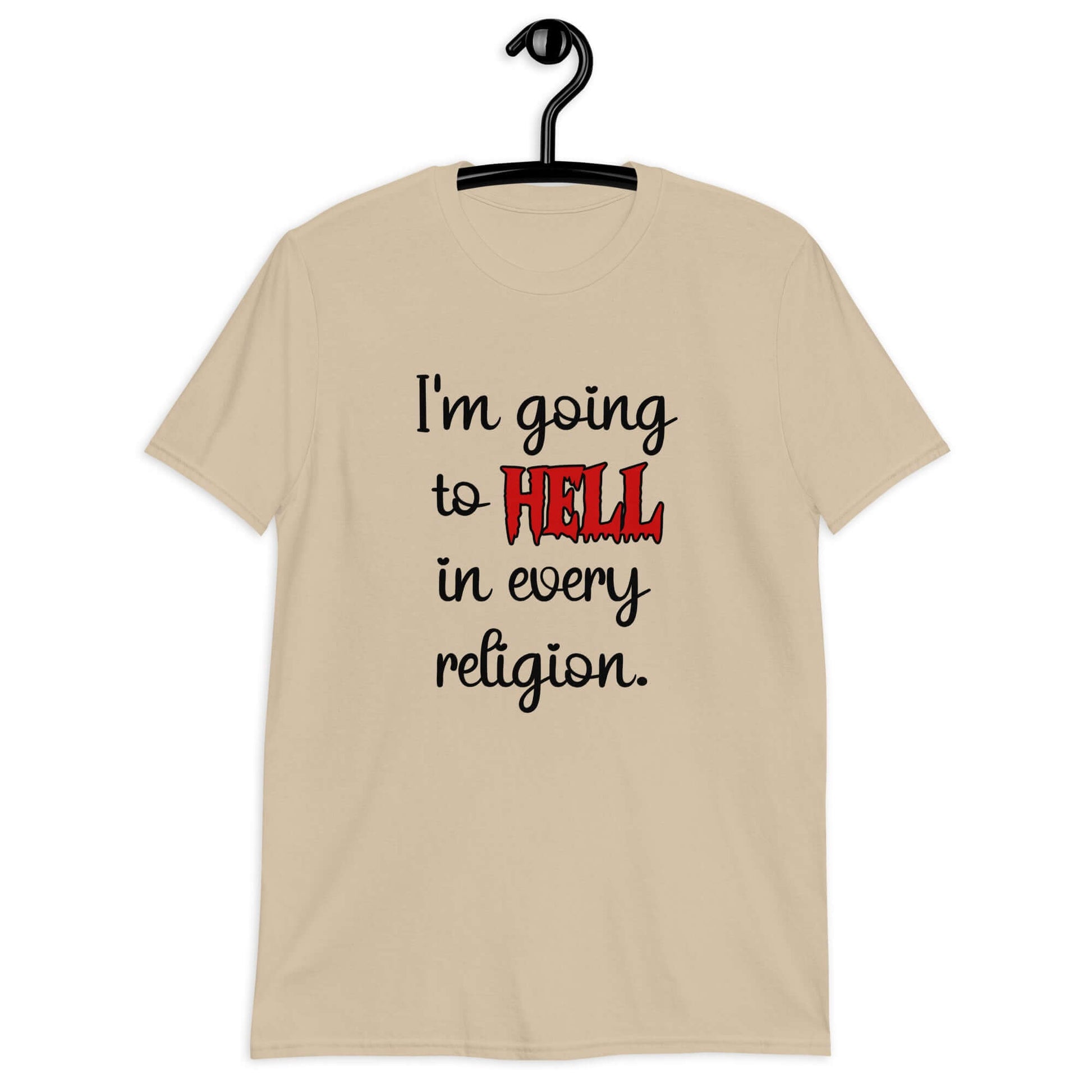 Sand color t-shirt with the phrase I'm going to hell in every religion printed on the front. The word hell is printed in red. The rest of the text is black.