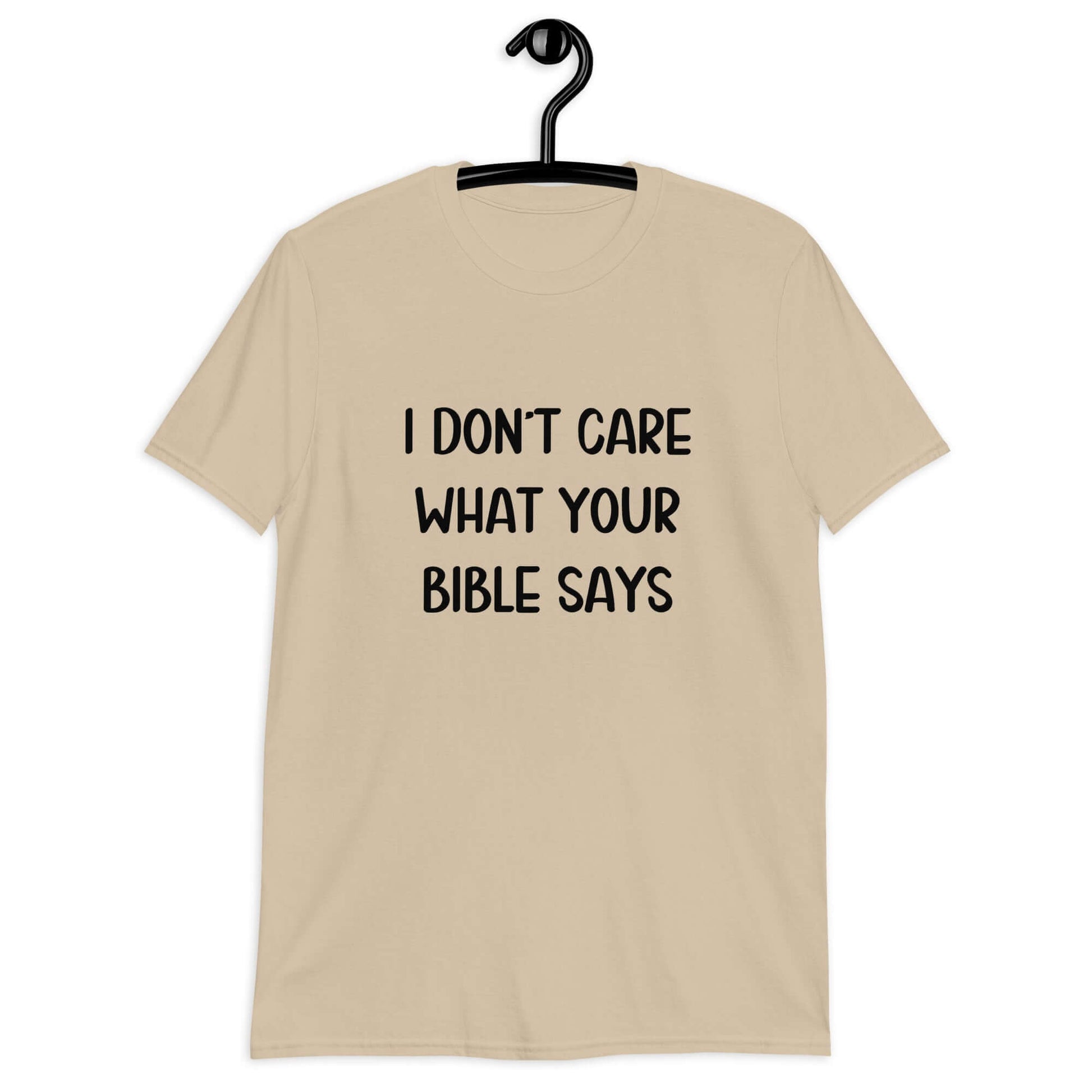 Sand color t-shirt with the phrase I don't care what your bible says printed on the front.