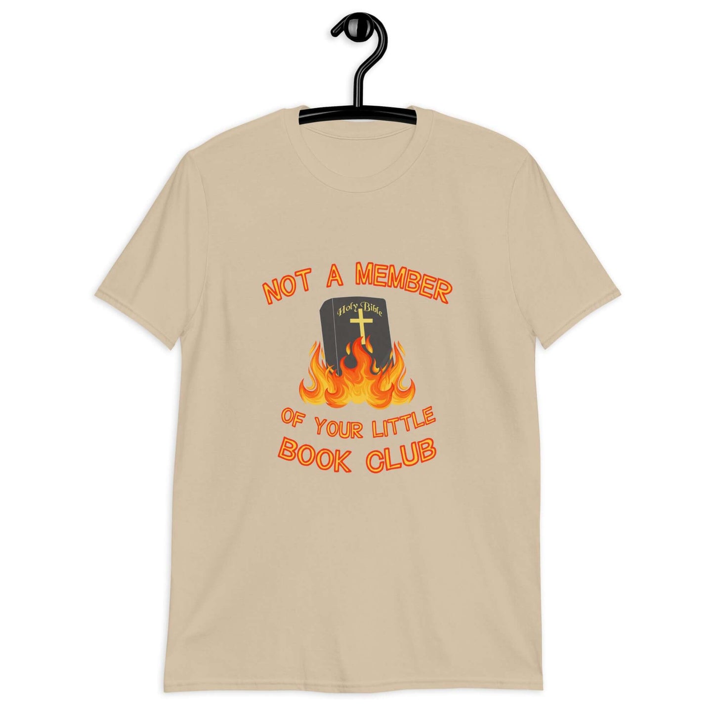 Sand color t-shirt with image of a burning bible and the words Not a member of your little book club printed on the front.