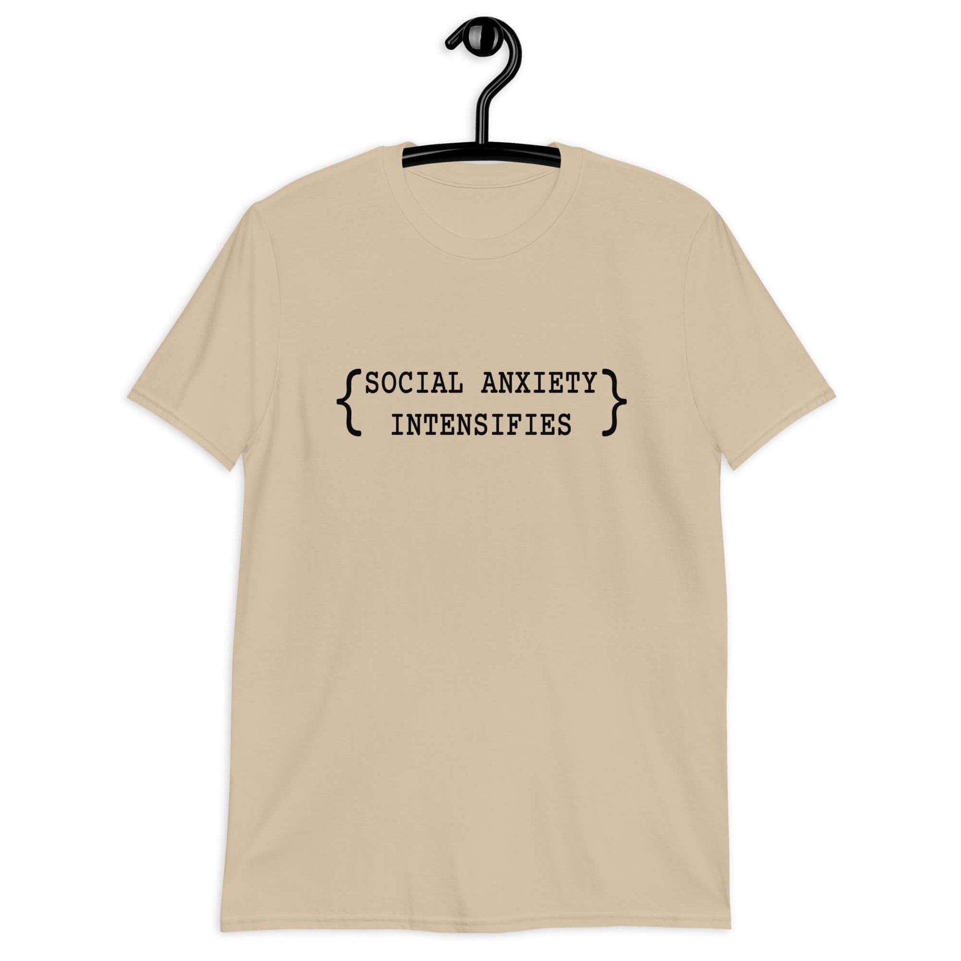 Sand color t-shirt with the words Social anxiety intensifies printed on the front.