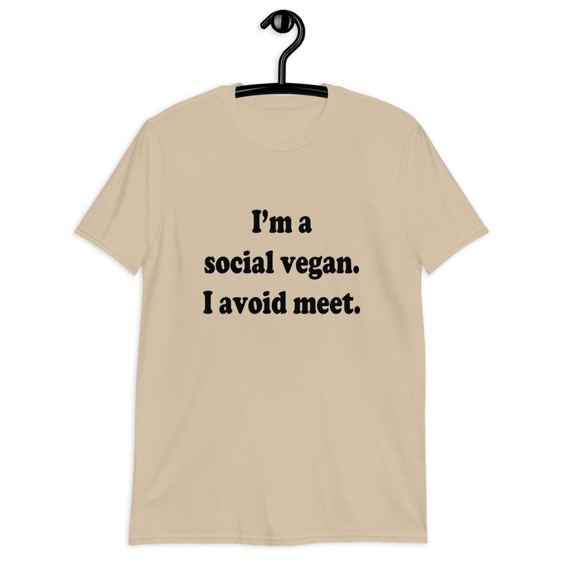 Sand t-shirt with the pun phrase I'm a social vegan, I avoid meet printed on the front.